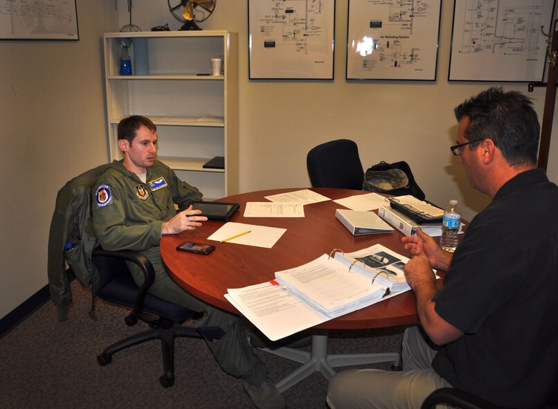 U.S. Air Force Tech Sgt. Joel Hildebrand, 63rd Air Refueling Squadron boom operator, receives a pre-flight briefing before performing operations on the boom operations weapons system trainer Nov. 1, 2014 at MacDill Air Force Base, FL. The BOWST is used to enhance operators' skills and capabilities by simulating a refueling mission in a real world environment. (U.S. Air Force photo/Senior Airman Xavier Lockley)