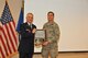 Col. Greg Semmel, Commander of the 174th Attack Wing presents Col. Richard D. Howard with a plaque in appreciation, recognition of service and dedication at his retirement ceremony. Howard served 34 years of service and retired on Nov. 1, 2014 at the 174th Attack Wing in Syracuse, NY. (New York Air National Guard Photo Tech. Sgt. Justin A. Huett/Released)