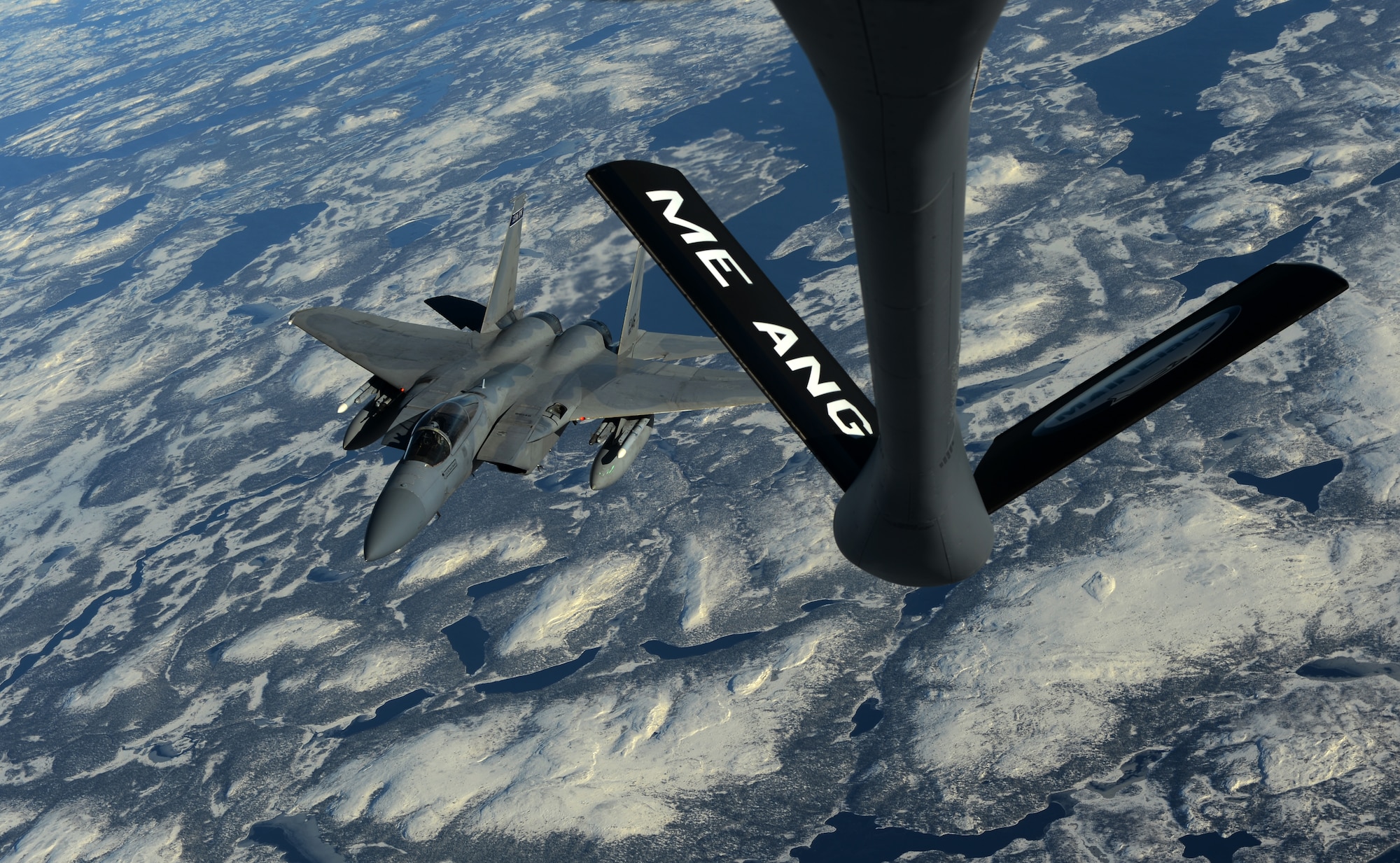 A 125th Fighter Wing F-15C Eagle pulls away from a KC-135 Stratotanker after refueling during Vigilant Shield 15 on Oct. 22, 2014, at 5 Wing Goose Bay, Newfoundland and Labrador, Canada. The 18th ARS conducted air refueling missions with U.S. Air Force and Royal Canadian Air Force aircraft during the field training exercise. The Vigilant Shield field training exercise is a bi-national NORAD Command exercise which provides realistic training and practice for American and Canadian forces in support of respective national strategy for North America’s defense. NORAD ensures U.S. and Canadian air sovereignty through a network of alert fighters, tankers, airborne early warning aircraft, and ground-based air defense assets cued by interagency and defense surveillance radars. (U.S. Air Force photo by Staff Sgt. Matthew B. Fredericks)