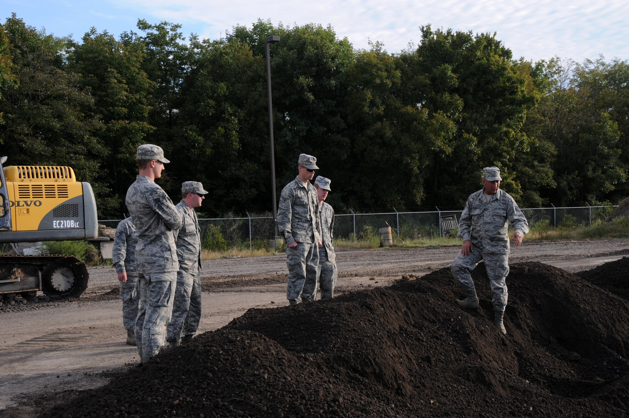 Members of the 188th Civil Engineering Squadron inspect a crater they made using heavy machinery during an exercise held at Ebbing Air National Guard Base, Fort Smith, Ark., Oct. 5, 2014. (U.S. Air National Guard photo by Airman 1st Class Cody Martin/Released)