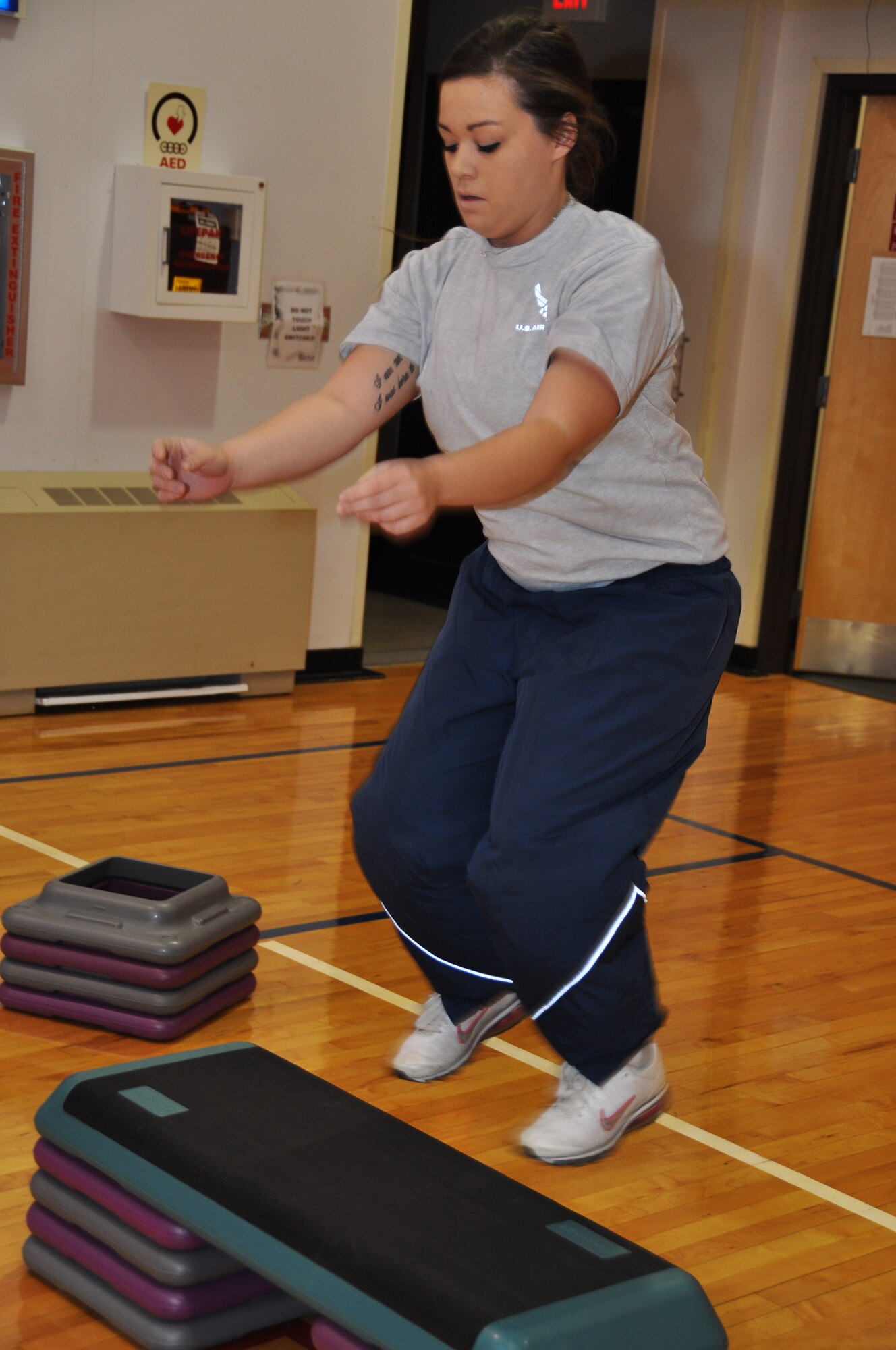 Airman Katherine Jarvis, medical technician with the 911th Aeromedical Staging Squadron, does box jumps at the base fitness center at the Pittsburgh International Airport Air Reserve Station, November 2, 2014. This Be Well Boot Camp session included 25 box jumps, 25 burpees, 25 pushups, a run and several other different exercises. (U.S. Air Force photo by Senior Airman Marjorie A. Bowlden)