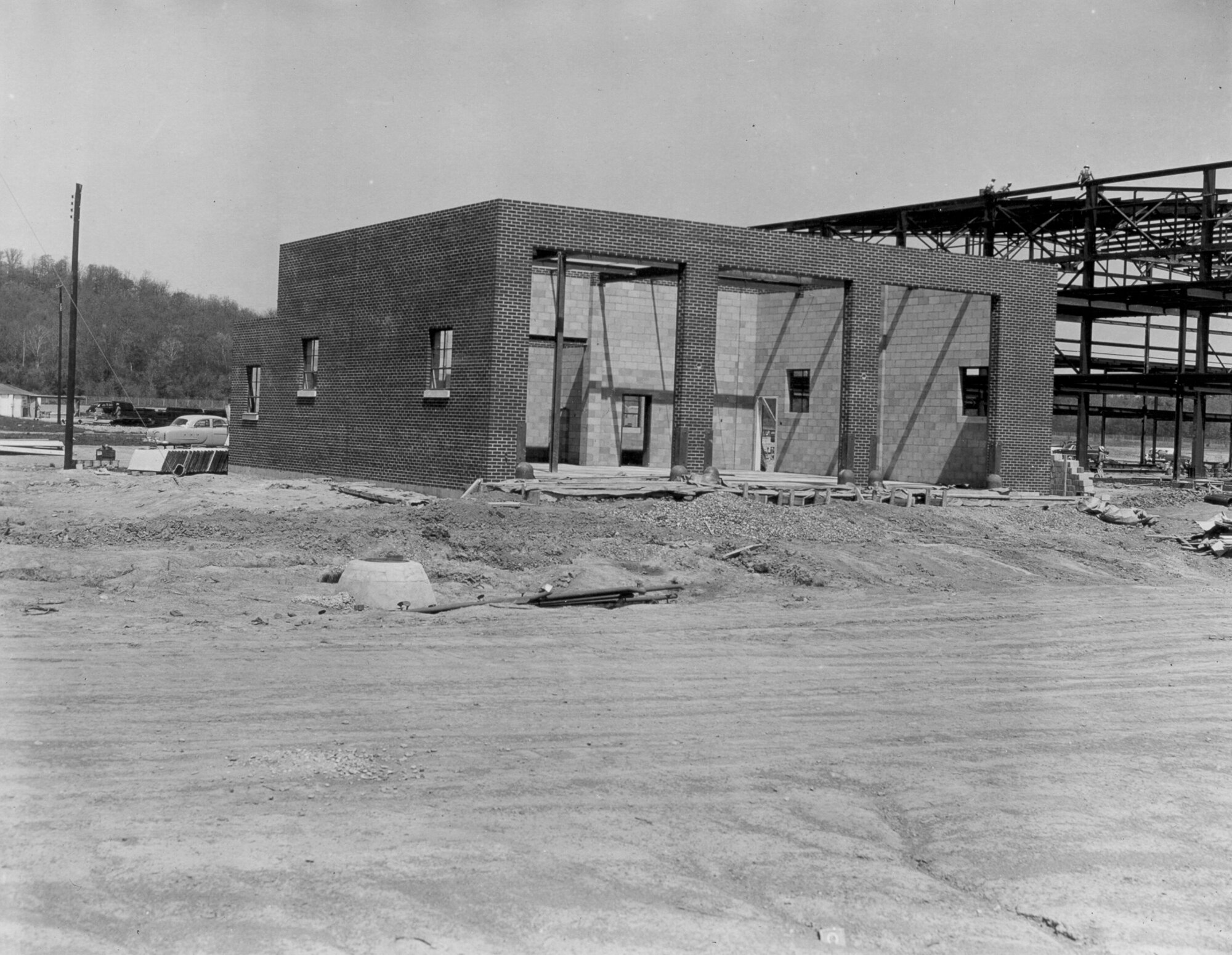 In this image, the 184th Tactical Reconnaissance Squadron Fire Department is under construction in conjunction with the aircraft hangar shown to the right. The building was completed in 1954 and still stands with multiple additions built into it. The 188th Wing began as the 184th Tactical Reconnaissance Squadron in 1953. This structure was one of the first buildings constructed on base. (Courtesy photo/released)