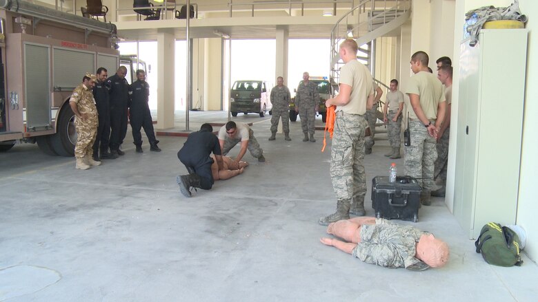 U.S. Air Force firefighters from the 379th Expeditionary Civil Engineer Squadron and firefighters from the Qatari Emiri Air Force perform dummy carry and drag techniques during bilateral training Oct. 30, 2014, at Al Udeid Air Base, Qatar. Training opportunities such as these allow fellow firefighters to share their different operating procedures during emergencies which help them respond to any and all hazards more effectively.