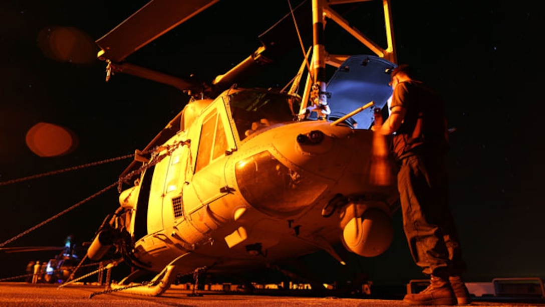 Corporal Mark F. Todd, an H-1 flight-line mechanic with the 24th Marine Expeditionary Unit’s Aviation Combat Element, Marine Medium Tiltrotor Squadron 365, conducts flight maintenance on a UH-1Y Huey aboard the USS Iwo Jima, Oct. 28, 2014. Marines conduct 24/7 flight maintenance to maintain mission readiness for all MEU aircraft. (U.S. Marine Corps photo by Sgt. Devin Nichols) (U.S. Marine Corps photo by Sgt. Devin Nichols)