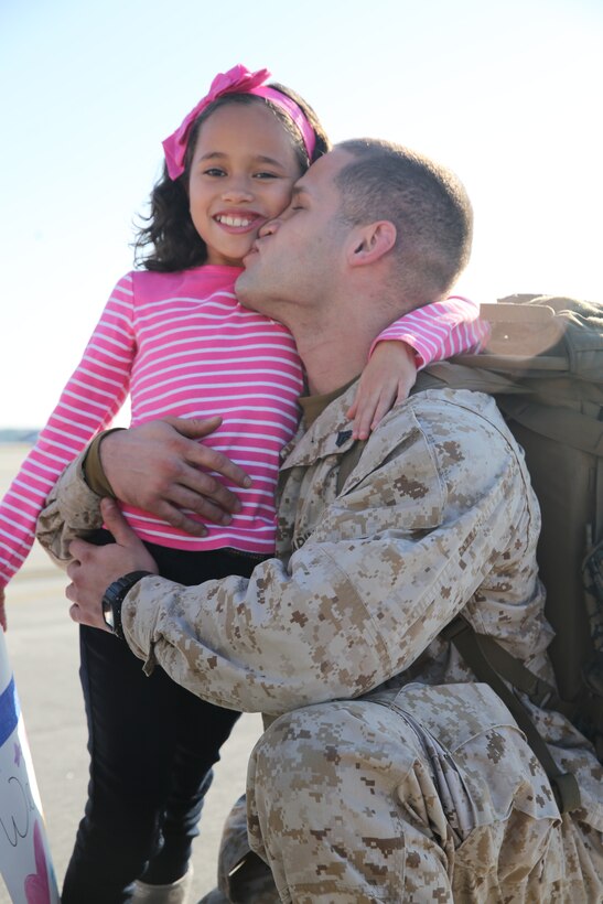 Cpl. Giovan Rodriguez kisses his 7-year-old daughter, Allyah, after returning from a nine-month deployment with the 22nd Marine Expeditionary Force aboard the USS Bataan to Marine Corps Air Station Cherry Point, N.C., Oct. 26, 2014. Rodriguez is a powerline mechanic with Marine Attack Squadron 223.
