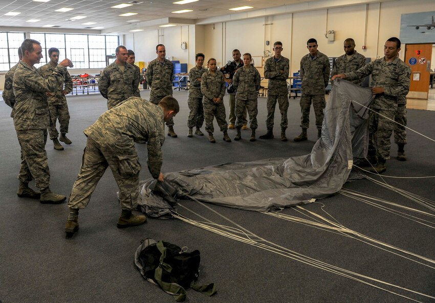 15th Operations Support Squadron Aircrew Flight Equipment Airmen explain how an MC-4 parachute works to Col. Randy Huiss, 15th Wing commander, and Chief Master Sgt. James Smith, 15th WG command chief, during their visit to the flight at Joint Base Pearl Harbor-Hickam, Hawaii, Oct. 24, 2014. (U.S. Air Force photo by Tech. Sgt. Terri Paden)