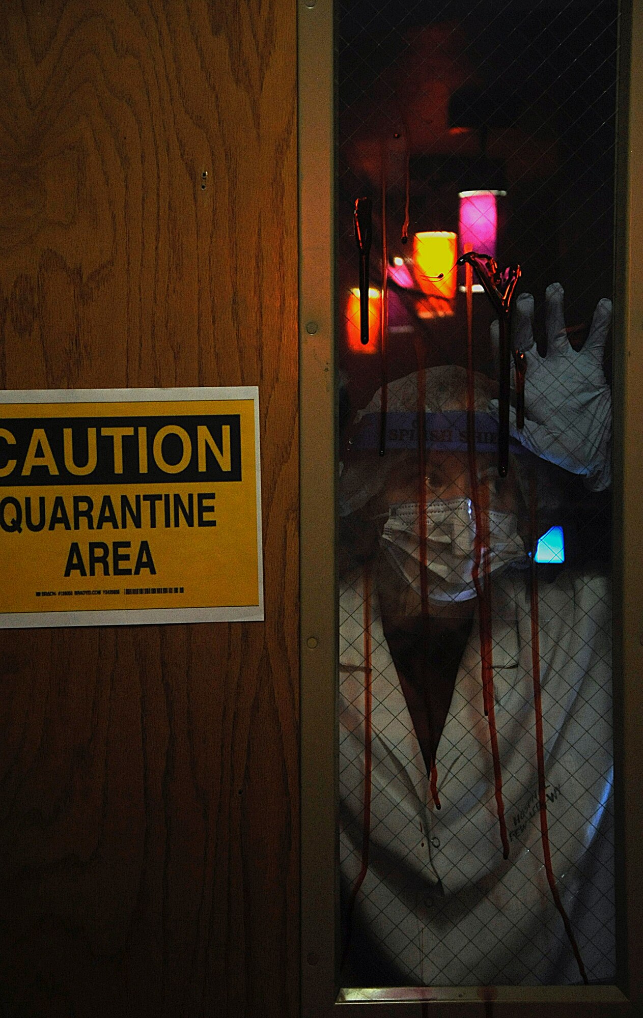 Staff Sgt. Erin Beaver, 90th Medical Operations Squadron, ominously stands behind a door to scaring those who pass by during the 90th Medical Group’s Trick or Treat event Oct. 31. Beaver was dressed up for their units Bubonic Plague theme. (U.S. Air Force photo by Airman 1st Class Brandon Valle)