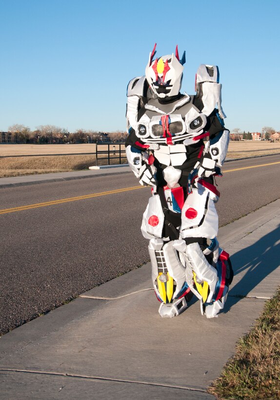 Staff Sgt. Angela McAllister, 90th Munitions Squadron NCO dressed as Jazz from the Transformers universe, nears the finish line of the 90th Force Support Squadron Halloween 5K Oct. 30, 2014. While the other participants fought through the cold morning run, McAllister's costume provided a bit more warmth. (U.S. Air Force photo by Senior Airman Jason Wiese)