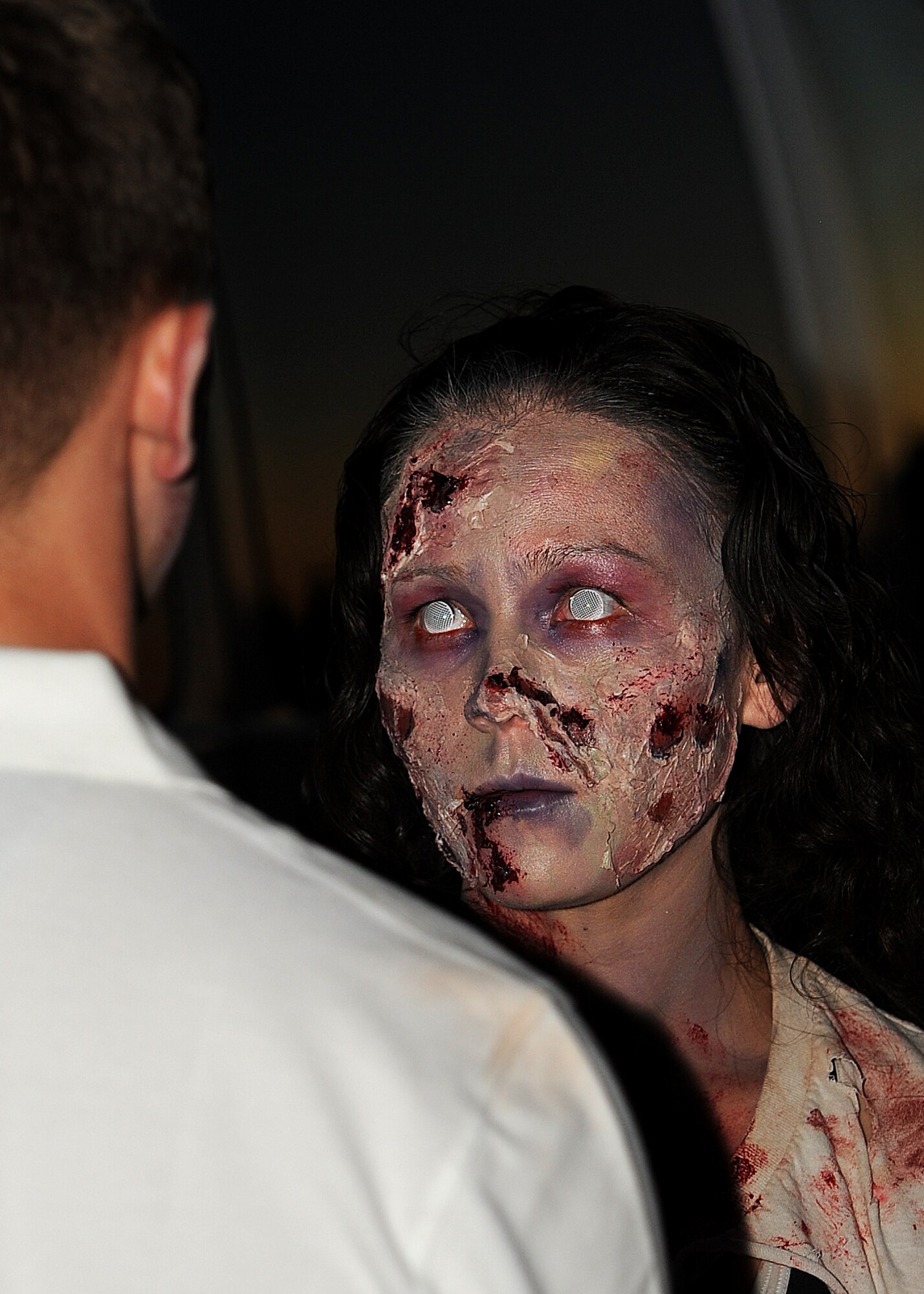 GOODFELLOW AIR FORCE BASE, Texas – Tech. Sgt. Jennifer A. Niblick, 17th Medical Support Squadron laboratory technician, puts make-up on a Goodfellow member during the 3rd annual Zombie Run outside the Event Center Oct. 31. The 17th Support Squadron hosted the event and gave awards for the fastest male and female runner as well as the best dressed male and female zombie. (U.S. Air Force photo/ Airman 1st Class Devin Boyer)