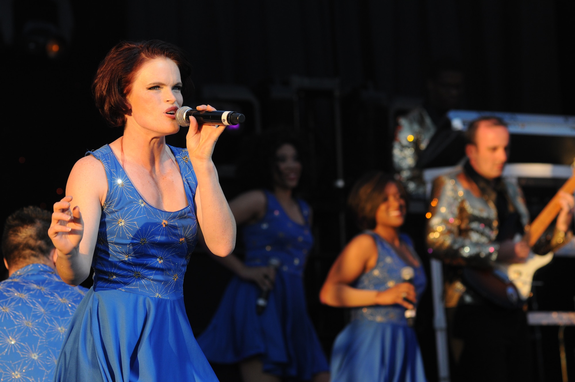 First Lt. Amanda Bills sings during a performance by Tops in Blue during their 2014 World Tour Nov. 1, 2014, behind the Levitow Training Support Facility, Keesler Air Force Base, Miss.  Hundreds of Keesler Airmen, families and retirees watched and listened as the Tops in Blue members performed their diverse show celebrating 60 years of tradition.  Bills is a personnel officer from the 707th Force Support Squadron, Fort Meade, Md. (U.S. Air Force photo by Kemberly Groue)
