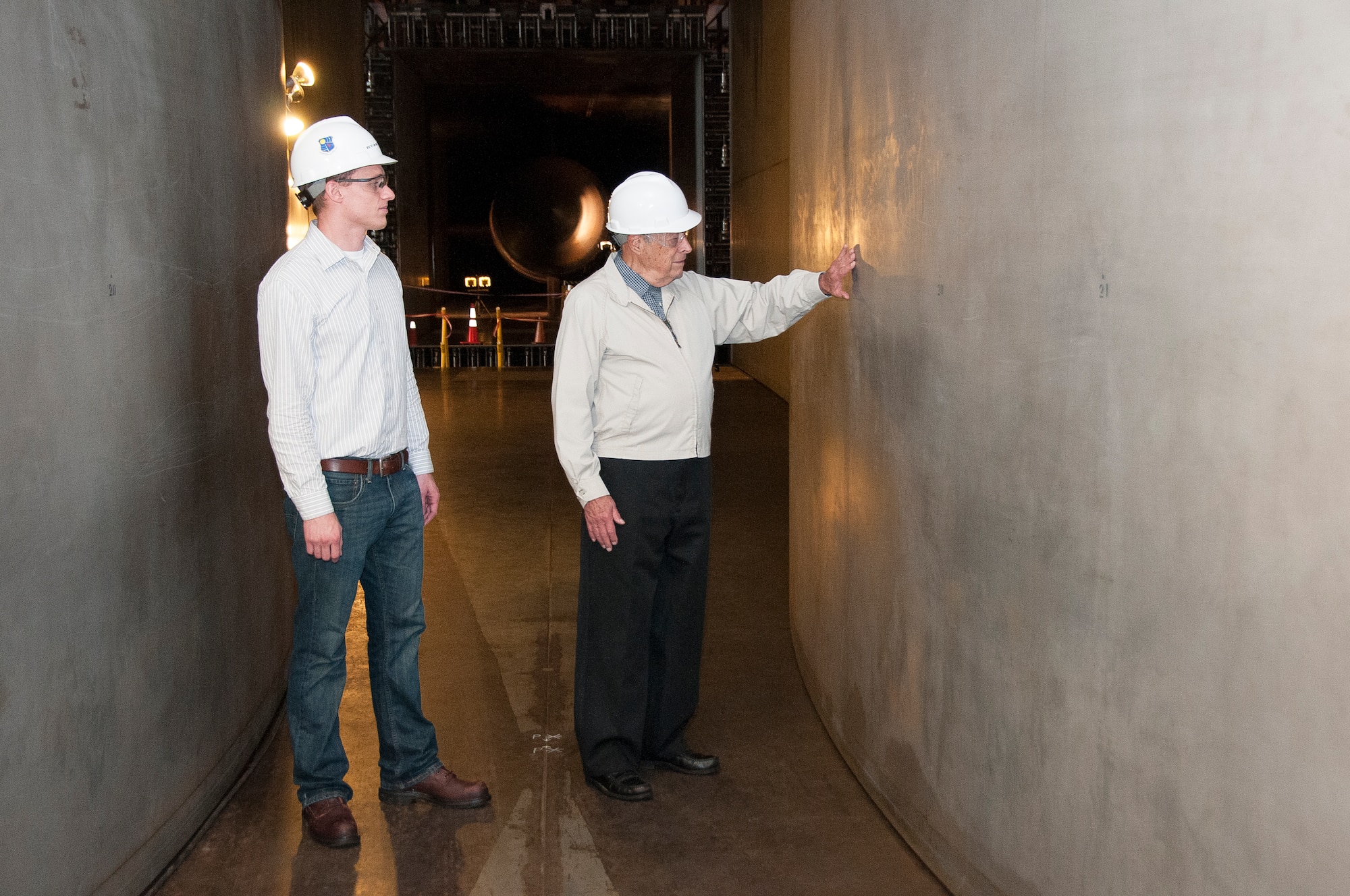 Robert Tatro, right, grandfather of Aerospace Testing Alliance (ATA) engineer Ryan Tatro, left, recently visited Arnold Engineering Development Complex (AEDC) to tour propulsion wind tunnels 16T and 16S, which he helped to design almost 60 years ago. (Photo by Rick Goodfriend)