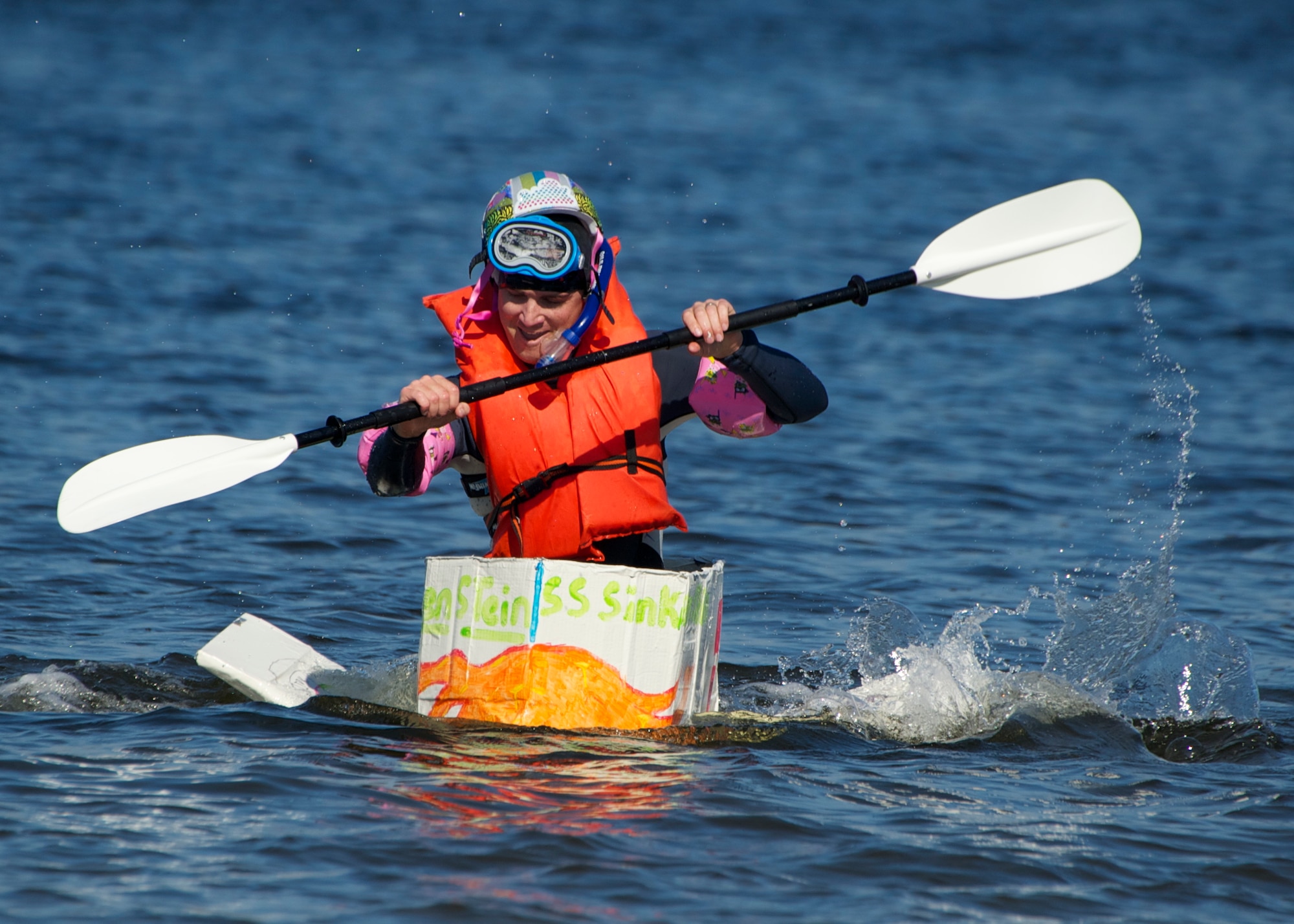 Maj. Paul Homan, commander of the 96th Weather Flight, attempts to catch his opponent in the cardboard boat race as part of the 96th Operations Group Fun in the Sun at Post’l Point Oct. 31. Various other events and competitions took place during the outing including volleyball, cornhole toss and tug-of-war.  The annual event coincided with the 96th Test Wing’s Wingman Day which focused on strengthening relationships and showing respect and resiliency in the workplace. (U.S. Air Force photo/Sara Vidoni)