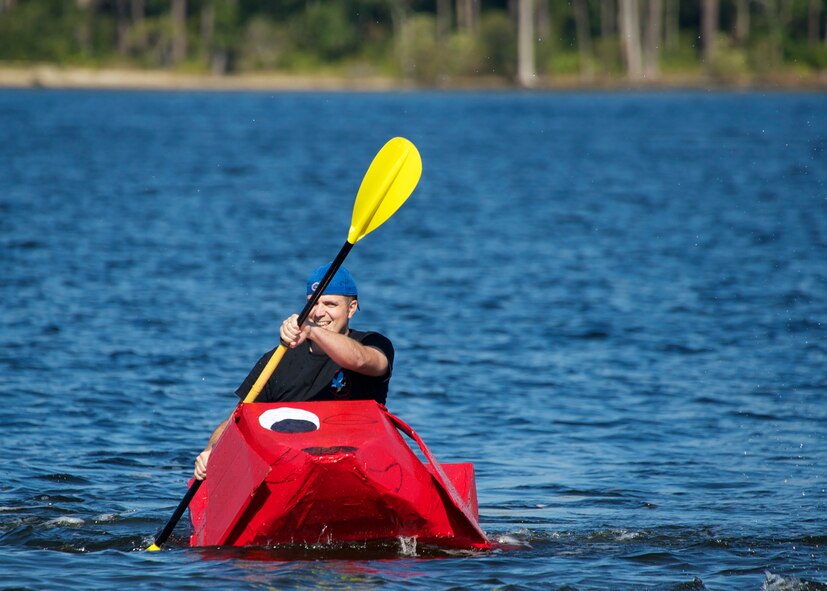 Capt. Phillip Fischer, of the Operation Flight Program Combined Test Force, steers his Clifford-themed boat toward the finish line during the cardboard boat race as part of the 96th Operations Group Fun in the Sun at Post’l Point Oct. 31. Various events and competitions took place during the outing including volleyball, cornhole toss, tug-of-war and a cardboard boat race.  The annual event coincided with the 96th Test Wing’s Wingman Day which focused on strengthening relationships and showing respect and resiliency in the workplace.  (U.S. Air Force photo/Sara Vidoni)