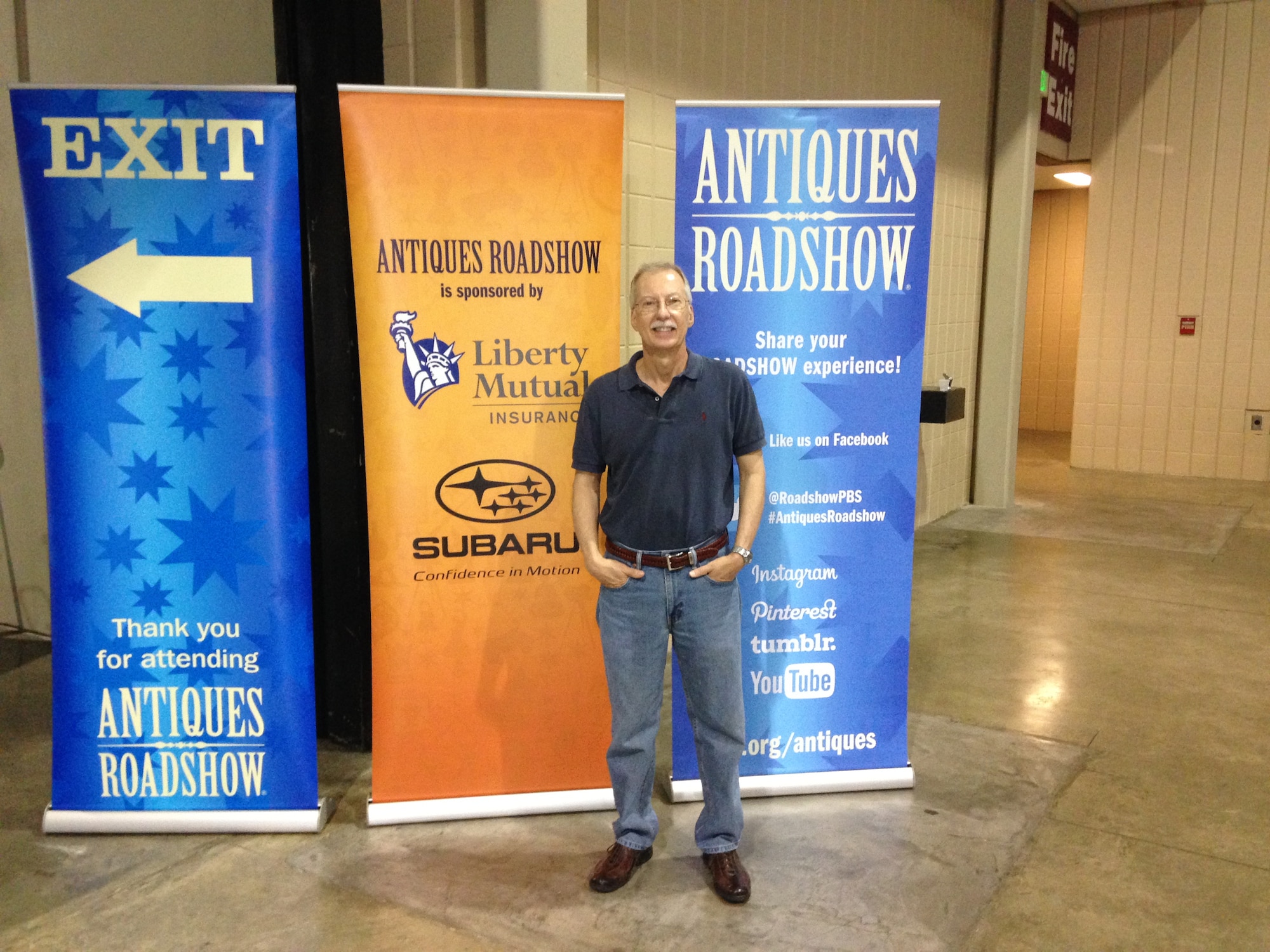 Ben Partin, with the Aerospace Testing Alliance (ATA) Safety, Health and Environmental Branch, stands in front of the Antiques Roadshow banners near the exit of the Birmingham-Jefferson Convention Complex after having his items appraised at the show on June 21. The exit is near the Feedback Booth where Roadshow participants are able to talk about their appraisal experience. (Photo provided)