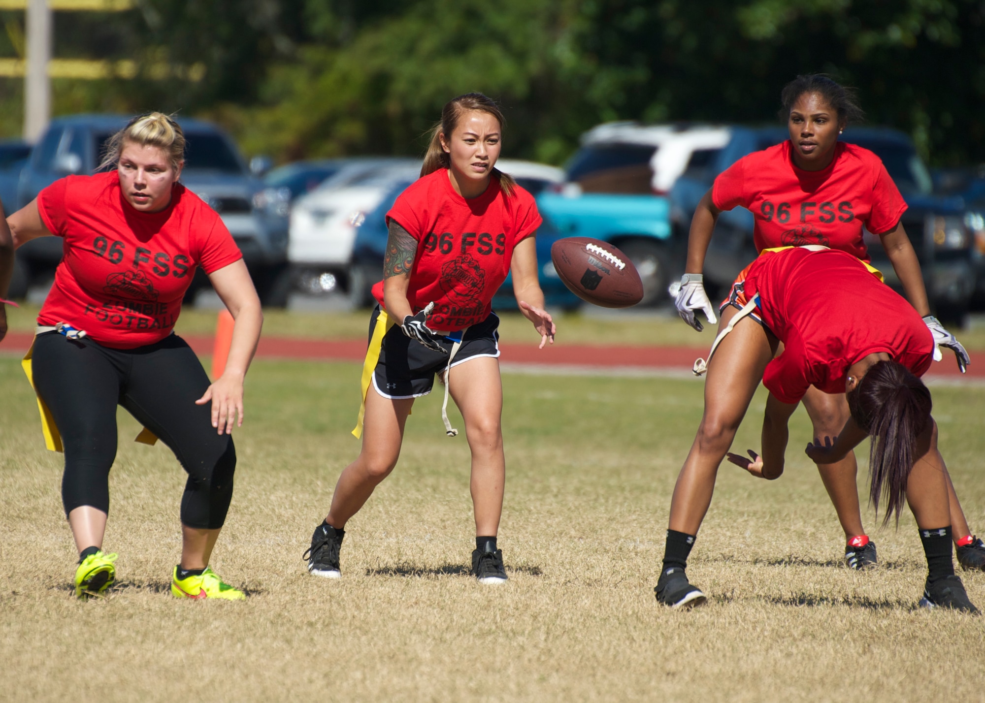 The 96th Force Support Squadron’s quarterback, Airman 1st Class Linda Cha, catches the snap to begin a play during their powderpuff football game against the 96th Logistic Readiness Squadron Oct. 31 at Eglin Air Force Base, Fla. LRS, the reigning champions, took home the win in a 13-0 victory by scoring a touchdown in each half and stopping FSS short in the red zone twice. The annual powderpuff game coincided with the 96th Test Wing’s Wingman Day which focused on strengthening relationships and showing respect and resiliency in the workplace. (U.S. Air Force photo/Sara Vidoni)