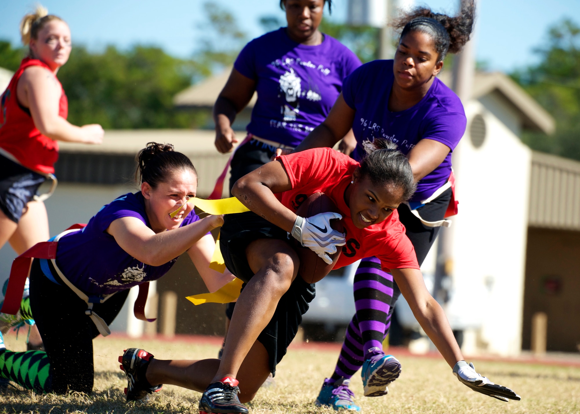 Tech. Sgt. Arisleyda Gonzalez, of the 96th Force Support Squadron, tries to escape three 96th Logistics Readiness Squadron defenders for more yardage during their powderpuff football game Oct. 31 at Eglin Air Force Base, Fla. LRS, the reigning champions, took home the win in a 13-0 victory by scoring a touchdown in each half and stopping FSS short in the red zone twice. The annual powderpuff game coincided with the 96th Test Wing’s Wingman Day which focused on strengthening relationships and showing respect and resiliency in the workplace. (U.S. Air Force photo/Sara Vidoni)