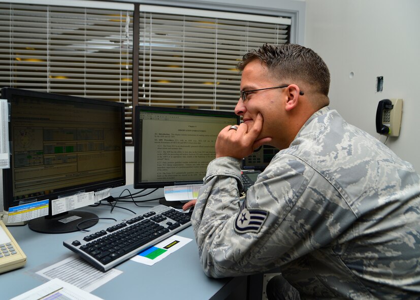 Staff Sgt. Charles Roper, 436th Operations Support Squadron weather technician, looks at the Joint Environmental Tool Oct. 30, 2014, at Dover Air Force Base, Del. The JET provides current information from the FMQ19 and is a central hub for weather data and information. (U.S. Air Force photo/Airman 1st Class William Johnson)