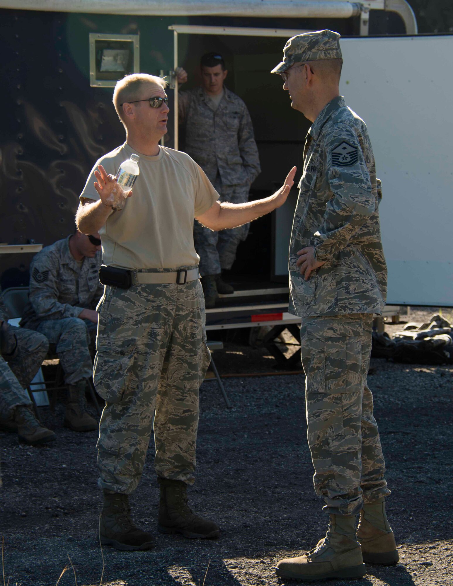 Tech. Sgt. Francis L. Hartley, member of the 482nd Communications Squadron at Homestead Air Reserve Base, Fla., swaps stories with Master Sgt. George T. Curry, a first sergeant with the 94th Communications Squadron at Dobbins Air Reserve Base, Ga., during a base recovery exercise at Homestead ARB on Oct. 18.  The exercise included five units from the Air Force Reserve and was used to give members a chance to practice setting up and draft operating instructions for the Joint Incident Site Communications Capability kits which are used during emergencies to keep key leaders and local first responders connected when there is a communications outage. (U.S. Air Force photo/Senior Airman Jaimi L. Upthegrove)