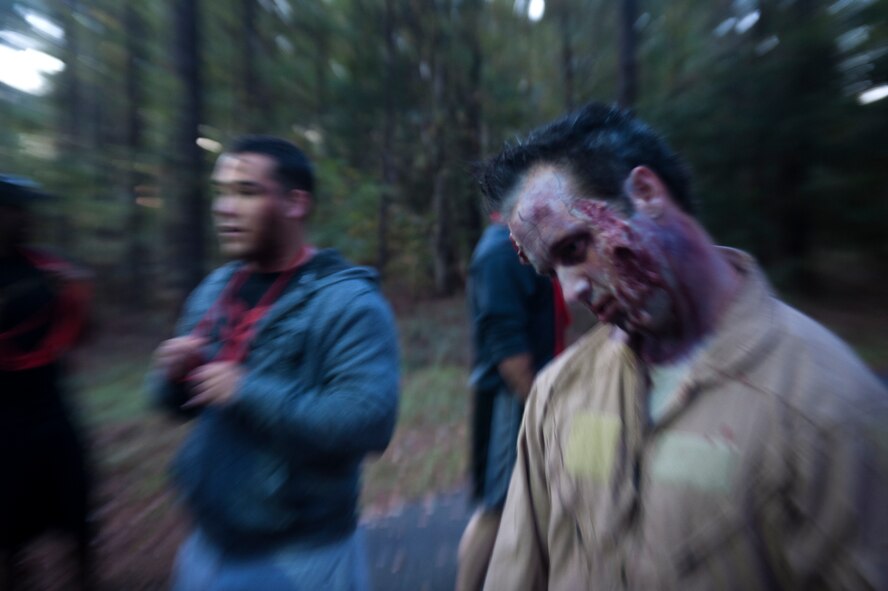 A group of “zombies” waits on a trail for runners during a Halloween zombie run Oct. 31, 2014, at Moody Air Force Base, Ga. If a runner lost all three red ribbons, the runner would switch to a blue ribbon and become a zombie. (U.S. Air Force photo by Senior Airman Jarrod Grammel/Released)
