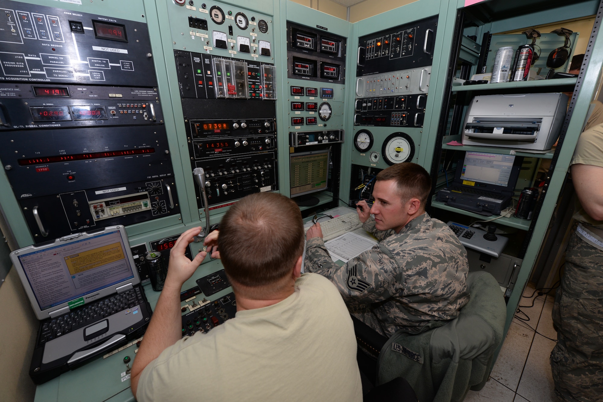 Tech Sgt. Joseph LeFors, 28th Maintenance Squadron test cell section chief (left) and Staff Sgt. Joshua Dean, 28th MXS assistant test cell section chief, perform a B-1 bomber engine test run at the engine test cell at Ellsworth Air Force Base, S.D., Sept. 12, 2014. The six-step engine flow testing process includes an inspection to determine work scope, maintenance, and a performance run. (U.S. Air Force photo by Airman 1st Class Rebecca Imwalle/ Released)
