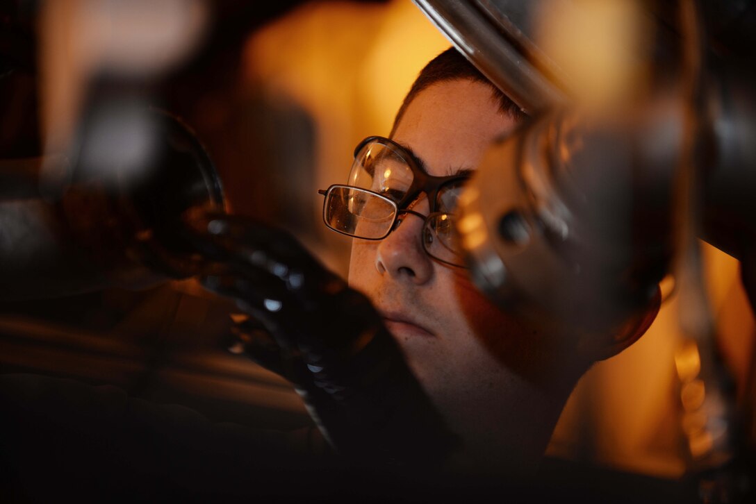Airman 1st Class Clinton Hutto, 28th Maintenance Squadron engine test cell technician, connects two fuel lines on a B-1 bomber engine at the engine test cell at Ellsworth Air Force Base, S.D., Sept. 12, 2014. The test cell has undergone recent upgrades and renovations to meet Ellsworth mission requirements. (U.S. Air Force photo by Airman 1st Class Rebecca Imwalle/ Released)