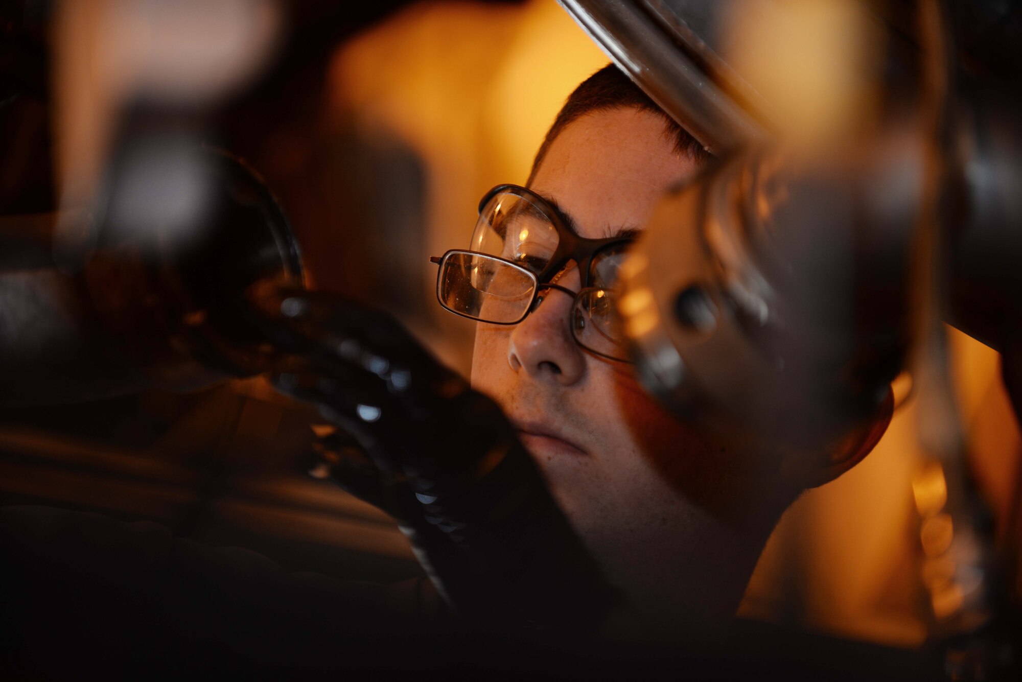 Airman 1st Class Clinton Hutto, 28th Maintenance Squadron engine test cell technician, connects two fuel lines on a B-1 bomber engine at the engine test cell at Ellsworth Air Force Base, S.D., Sept. 12, 2014. The test cell has undergone recent upgrades and renovations to meet Ellsworth mission requirements. (U.S. Air Force photo by Airman 1st Class Rebecca Imwalle/ Released)
