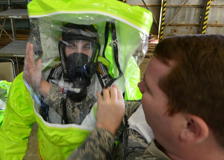 Senior Master Sgt. Jeff Rose helps Airman Erika Lis, 919th Special Operations Civil Engineer Squadron’s emergency management office, into a hazardous material suit during a training exercise Nov. 1 at Duke Field, Fla. The exercise tested the interoperability of fire and emergency management Airmen during a response to an aircraft fire/HazMat emergency scenario. (U.S. Air Force photo/ Tech. Sgt. Cheryl L. Foster)