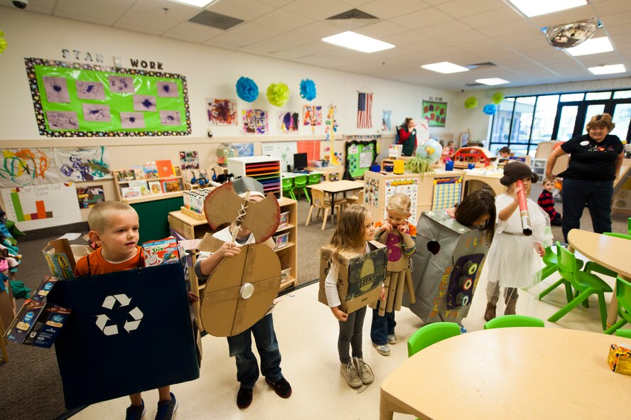Children from the Child Development Center II line up during a recycled materials costume contest judging Oct. 31, 2014, at Moody Air Force Base, Ga. Children had to create a costume made of recycled items in order to be eligible. (U.S. Air Force photo by Senior Airman Olivia Bumpers/Released)