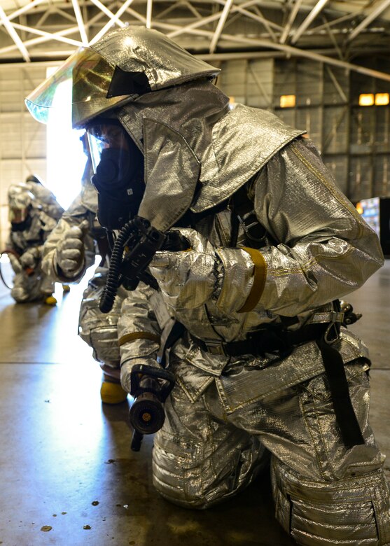 Firefighters from 919th Special Operations Civil Engineer Squadron wait for directions from their on-site commander during a training exercise Nov. 1 at Duke Field, Fla. The exercise tested the interoperability of fire and emergency management Airmen during a response to an aircraft fire/HazMat emergency scenario. (U.S. Air Force photo/ Tech. Sgt. Cheryl L. Foster)
