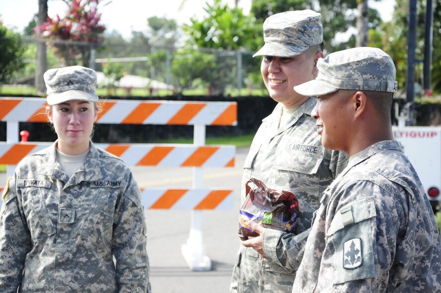 Hawaii Army and Air National Guardsmen man security checkpoints and pass out candy to trick-or-treaters in Pahoa, Hawaii, Oct. 31, 2014. Hawaii Army and Air National Guardsmen were called to the area called to support the Hawaii County Civil Defense as the Puna lava flow makes its way downslope. They patrolled neighborhoods and blocked roads from curious onlookers as the lava flow advances towards homes. (U.S. Army National Guard photo by Staff Sgt. Katie Gray/Released)

