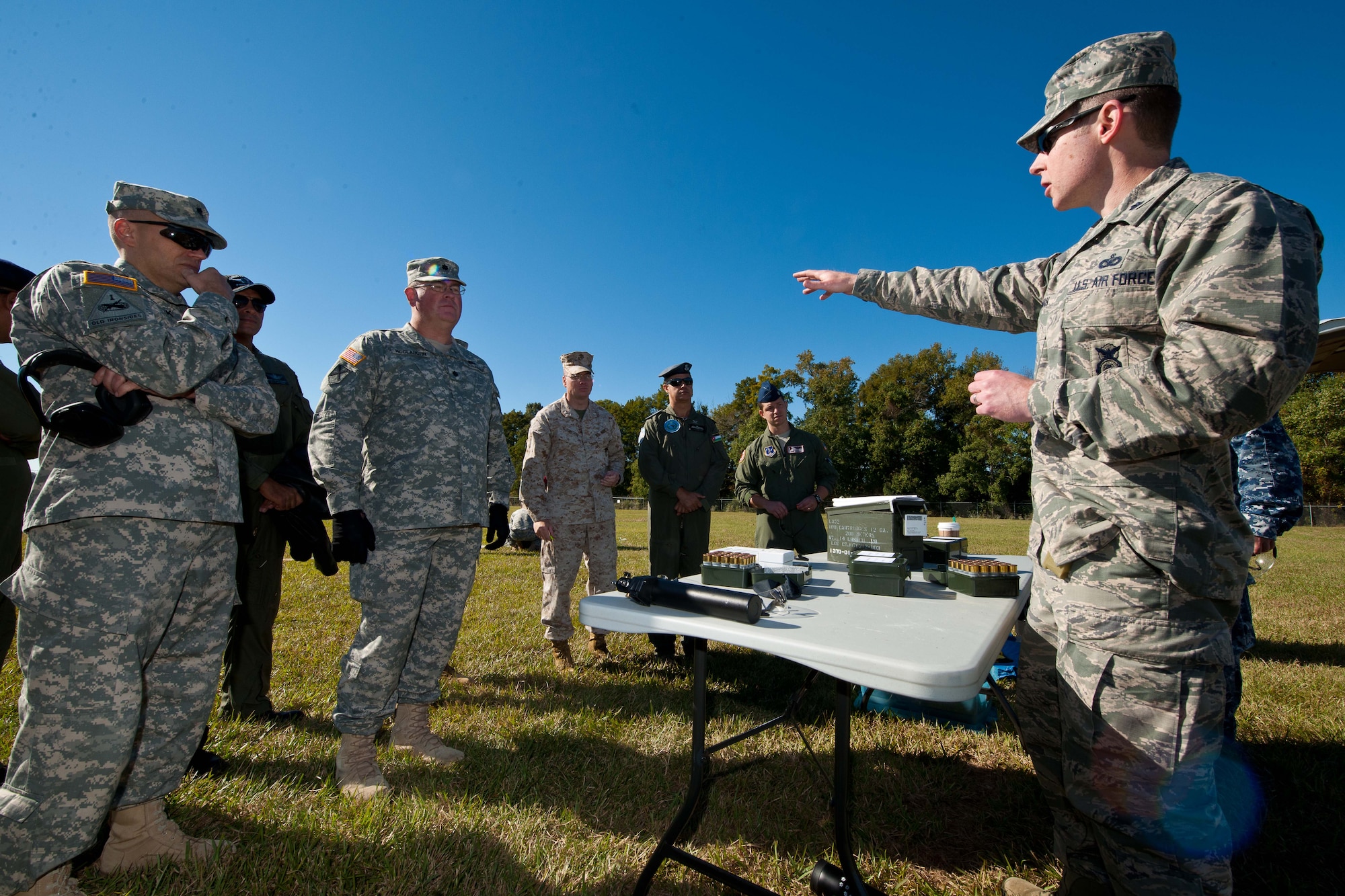Lt. Col. Dave Osterman, Joint Non-Lethal Weapons Directorate capabilities and requirements division chief,  explains the flash-bang non-lethal weapons ammunition to Air War College students during a Non-lethal Weapons and Effects class at Maxwell Air force Base, Alabama, Oct. 23, 2014. Weapons introduced included the stun gun and bean bag rounds. (U.S. Air Force photo by Donna L. Burnett)