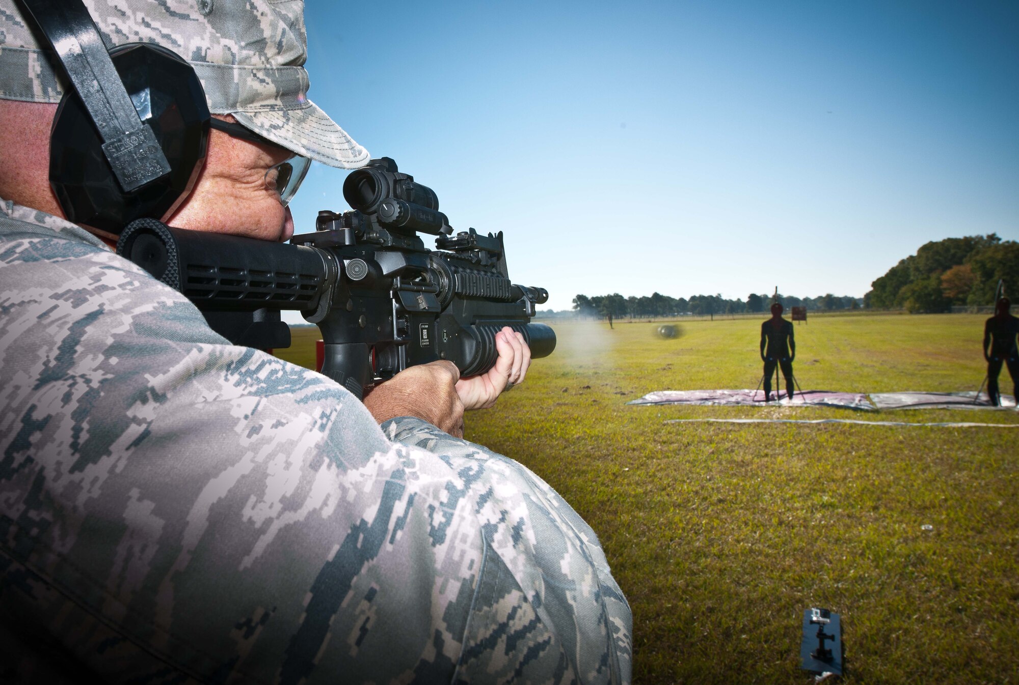 Lt. Col. Robert Waarik, Air War College student, practices shooting non-lethal ammunition at a target during a Non-lethal Weapons and Effects class at Maxwell Air Force Base, Alabama, Oct. 23, 2014. The use of non-lethal weapons gives military members more options when defending themselves and others. (U.S. Air Force photo by Donna L. Burnett)