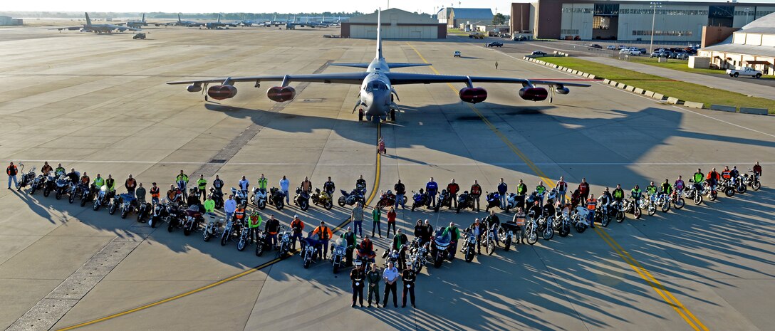 Col. Kristin Goodwin, 2nd Bomb Wing commander, and Chief Master Sgt. Tommy Mazzone, 2nd BW command chief, pose with the Green Knights chapter 75 and base motorcyclists  in front of a B-52H Stratofortress on Barksdale Air Force Base, La., Oct. 31, 2014. More than 50 riders gathered to commemorate the third annual celebration of Cajun Rumble. (U.S. Air Force photo/Airman 1st Class Curt Beach)