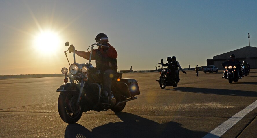 Motorcyclists cruise onto the flightline to prepare for a group photo as part of Cajun Rumble on Barksdale Air Force Base, La., Oct. 31, 2014. Since its formation in 2009, chapter 75 has participated in safety awareness and mentorship rides, and has supported local veterans' events. (U.S. Air Force photo/Airman 1st Class Curt Beach)