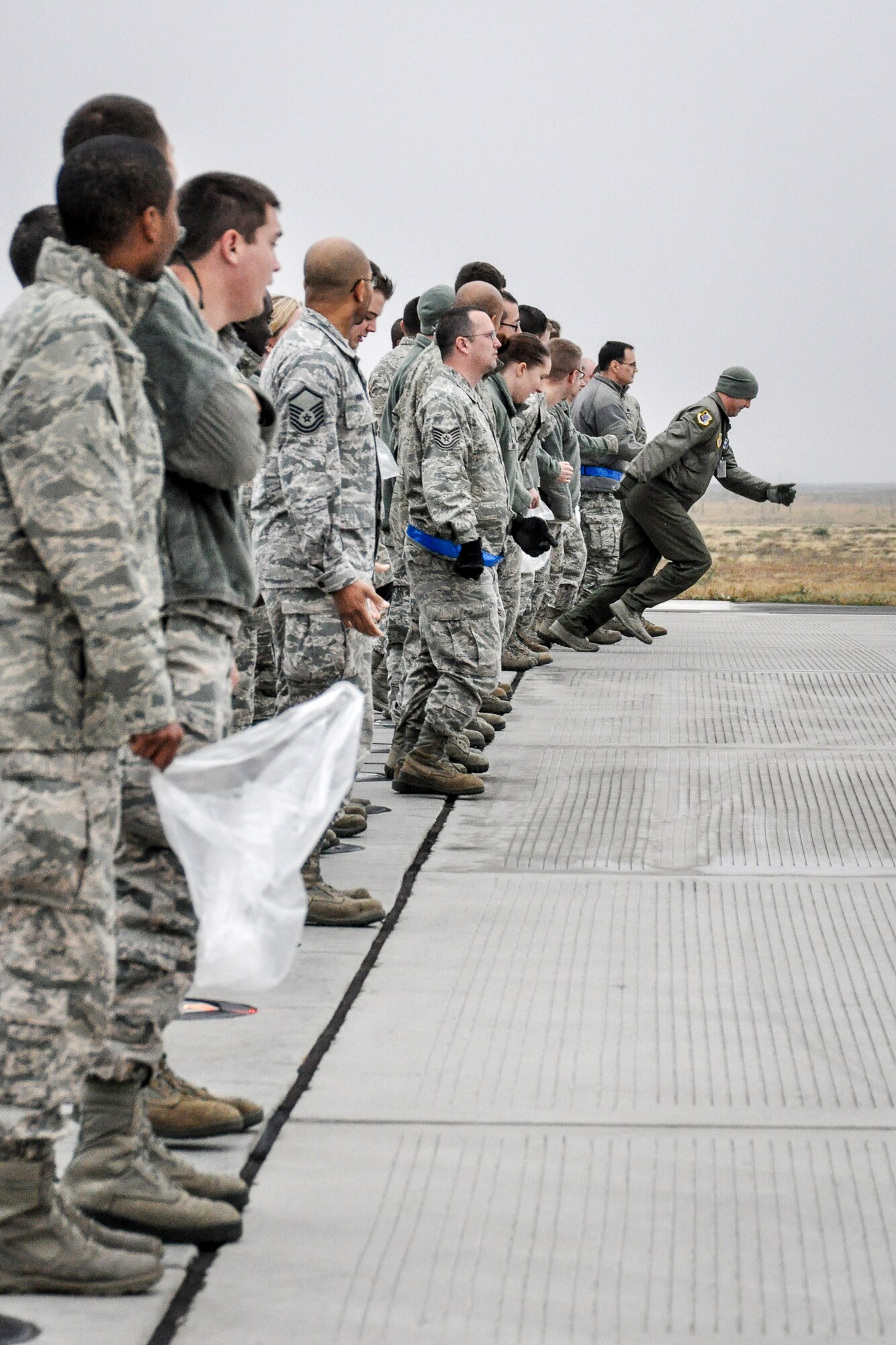 Fairchild Airmen begin looking for foreign object damage items like something as simple as a rock or pebble that could potentially get sucked up into a jet’s engine causing millions in damage at Fairchild Air Force Base, Wash., Oct. 31, 2014. Members who find the legendary golden bolt receive a certificate and a day off from work. This year’s recipient is Airman 1st Class Ian Wyle, a 92nd Operations Support Squadron air traffic control apprentice. (U.S. Air Force photo/Capt. David Liapis)