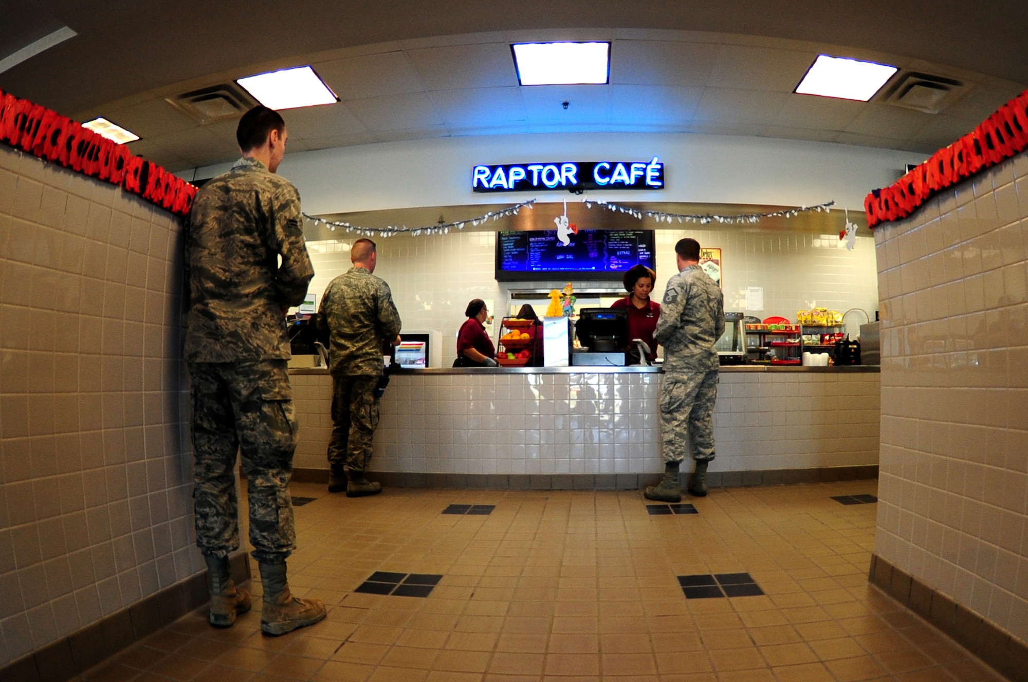 U.S. Air Force Airmen grab lunch at the Raptor Cafe at Langley Air Force Base, Va., Oct. 30, 2014. The Raptor Cafe aims to make it easier for workers and maintainers from the flight line and pilots to get a hot meal or something quick on the go. (U.S. Air Force photo by Airman 1st Class Areca T. Wilson/Released) 