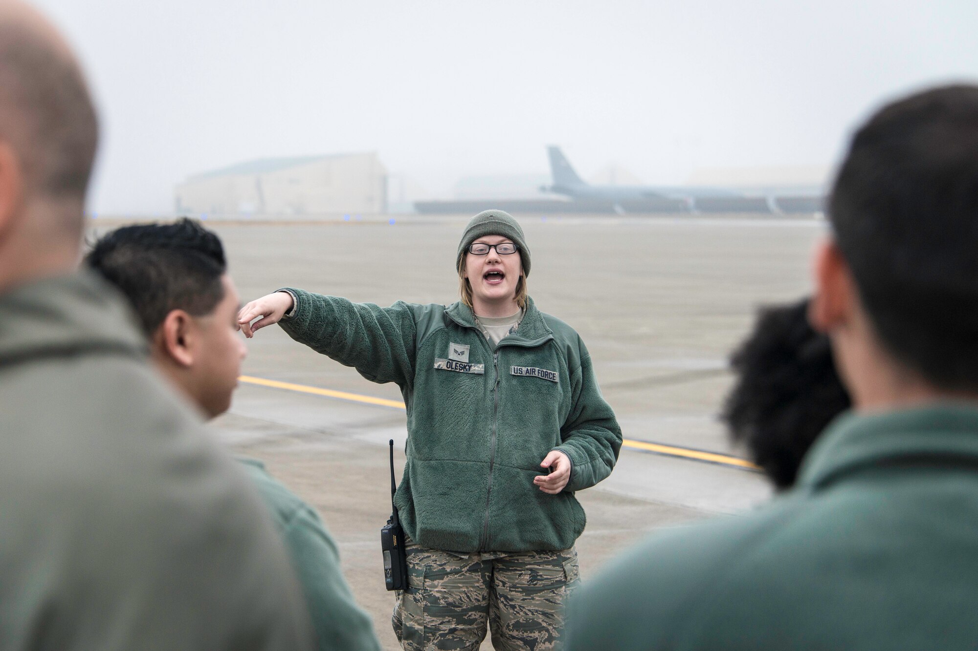 Senior Airman Mary Olesky explains the importance of foreign object damage walks and the logistics for the walk Fairchild Airmen are about to accomplish at Fairchild Air Force Base, Wash., Oct. 31, 2014. FOD walks ensure something as simple as a rock or pebble never has the chance of crippling a Team Fairchild jet. Olesky is a 92nd Operations Support Squadron airfield management operations supervisor. (U.S. Air Force photo/Staff Sgt. Benjamin W. Stratton)