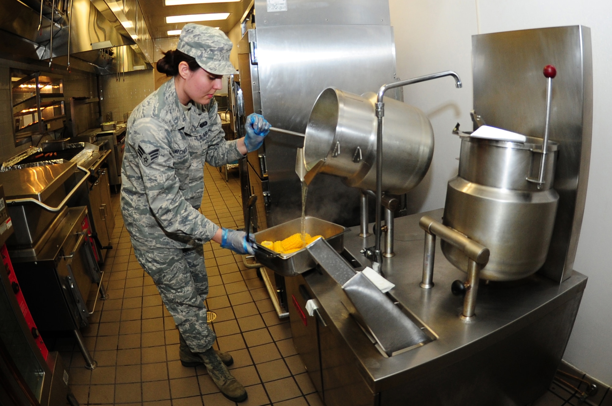 U.S. Air Force Senior Airman Alycia Atchisson, 633rd Force Support Squadron morning shift leader, prepares corn before lunch at the Raptor Café on Langley Air Force Base, Va., Oct. 30, 2014. The Raptor Café offers “grab and go” food options for individuals on the run that cannot dine in at the facility. (U.S. Air Force photo by Airman 1st Class Areca T. Wilson/Released) 