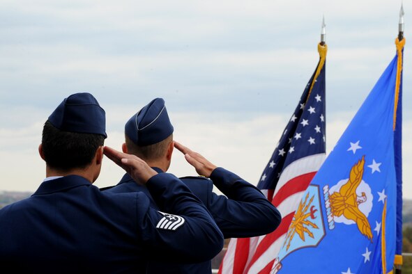 Maj. Mark Fogle and Tech. Sgt. Christopher Ferrell salute the flag as the National Anthem is played during a Purple Heart Medal presentation ceremony at the Air Force Memorial in Arlington, Va., Oct. 31, 2014. Ferrell was presented the Purple Heart Medal for injuries he received while conducting a direct action operation in Sangin, Afghanistan, in 2009. Ferrell is an explosive ordnance disposal technician assigned to the 11th Civil Engineer Squadron at Joint Base Andrews, Md. Fogle is the 366th Training Squadron/Detachment 3 commander at Eglin Air Force Base, Fla. (U.S. Air Force photo/Master Sgt. Tammie Moore)