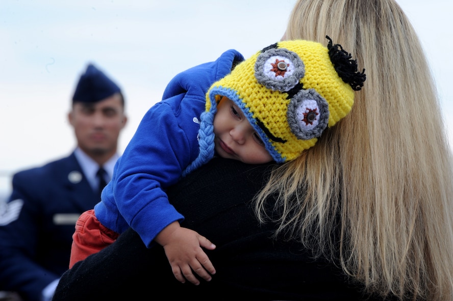 Lauren Ferrell holds her son, Maximus, as she listens to a speaker during a Purple Heart Medal presentation ceremony for her husband, Tech. Sgt. Christopher Ferrell, at the Air Force Memorial in Arlington, Va., Oct. 31, 2014. Ferrell was presented the Purple Heart Medal for injuries he received while conducting a direct action operation in Sangin, Afghanistan, in 2009. Ferrell is an explosive ordnance disposal technician assigned to the 11th Civil Engineer Squadron at Joint Base Andrews, Md. (U.S. Air Force photo/Master Sgt. Tammie Moore) 