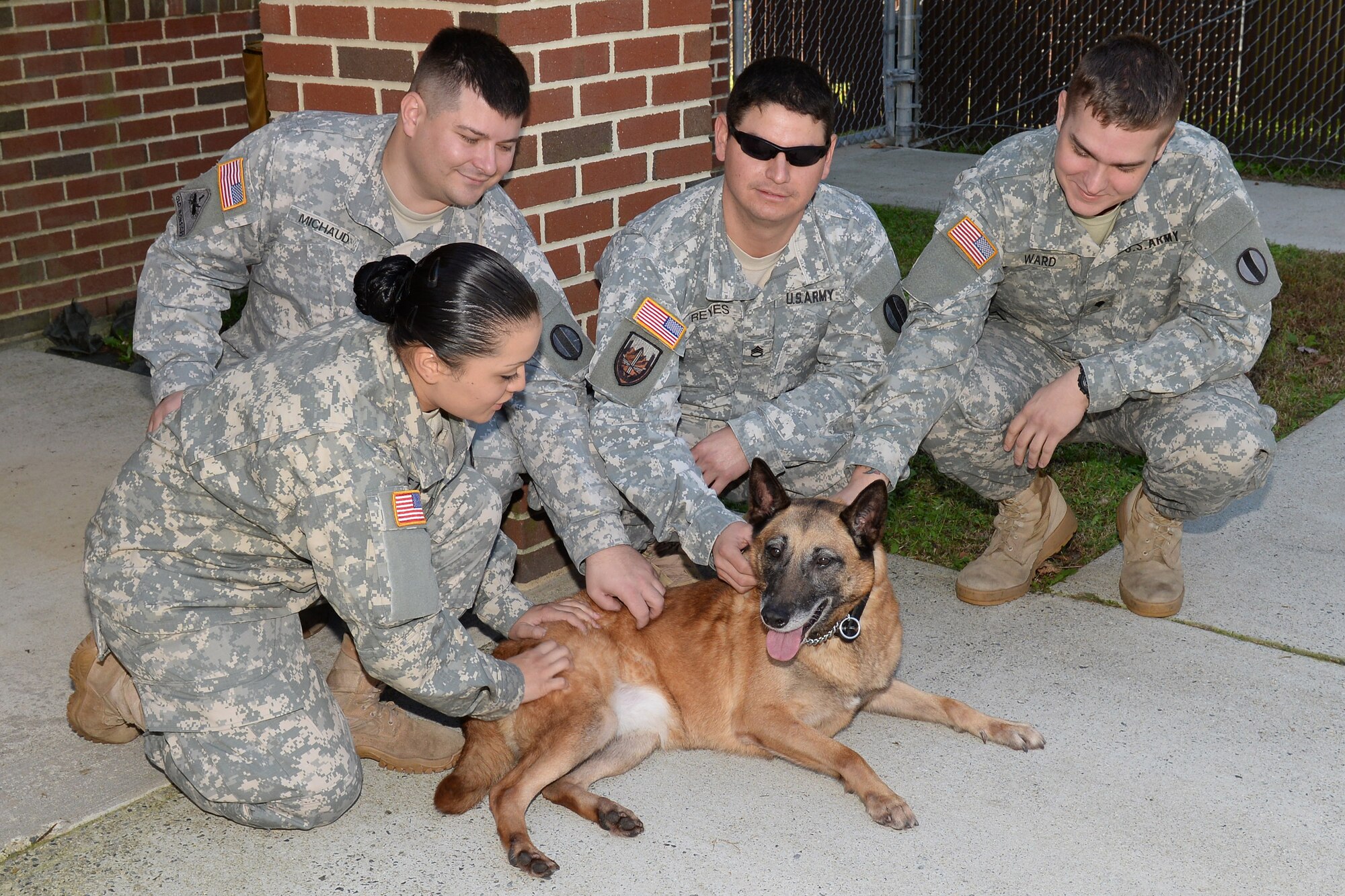 Members of the 3rd Military Police Detachment bid farewell to Shay, a 10-year-old military working dog, after she is adopted by former U.S. Army Sgt. Matthew Bedortha, previously assigned to the 3rd Military Police Det., at Fort Eustis, Va., Oct., 31, 2014. The adoption process for a MWD is long and requires a lot of paperwork, but Bedortha said it was worth it to be able to adopt his former partner. (U.S. Air Force photo by Staff Sgt. Teresa J. Cleveland/Released) 