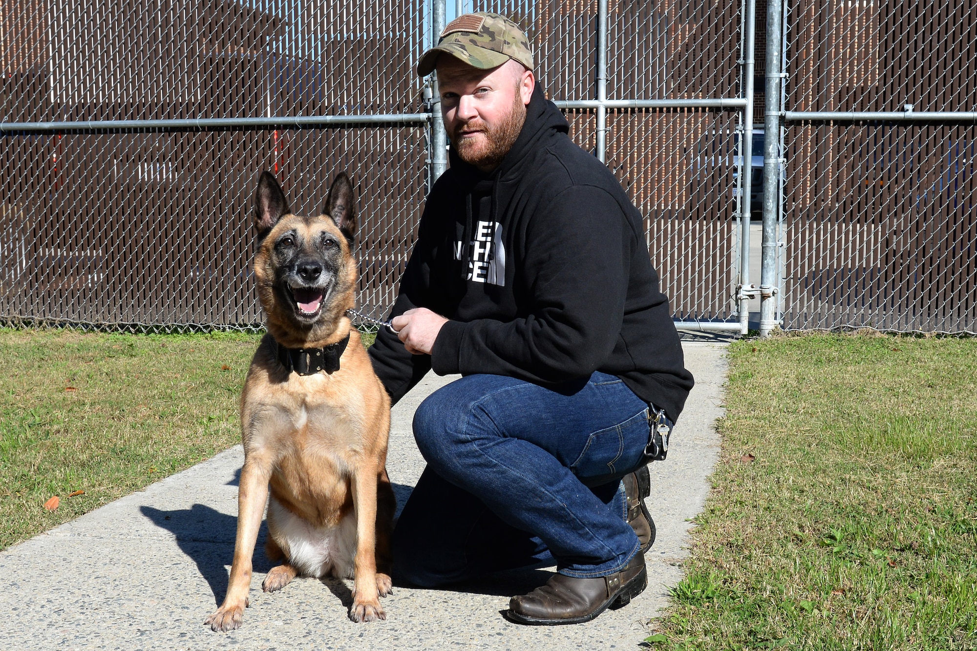 Former U.S. Army Sgt. Matthew Bedortha, previously assigned to the 3rd Military Police Det., adopts Shay, a 10-year-old military working dog, as both separate from military service at Fort Eustis, Va., Oct., 31, 2014. Bedortha and Shay were partners from Aug. 2010 to June 2012. (U.S. Air Force photo by Staff Sgt. Teresa J. Cleveland/Released) 