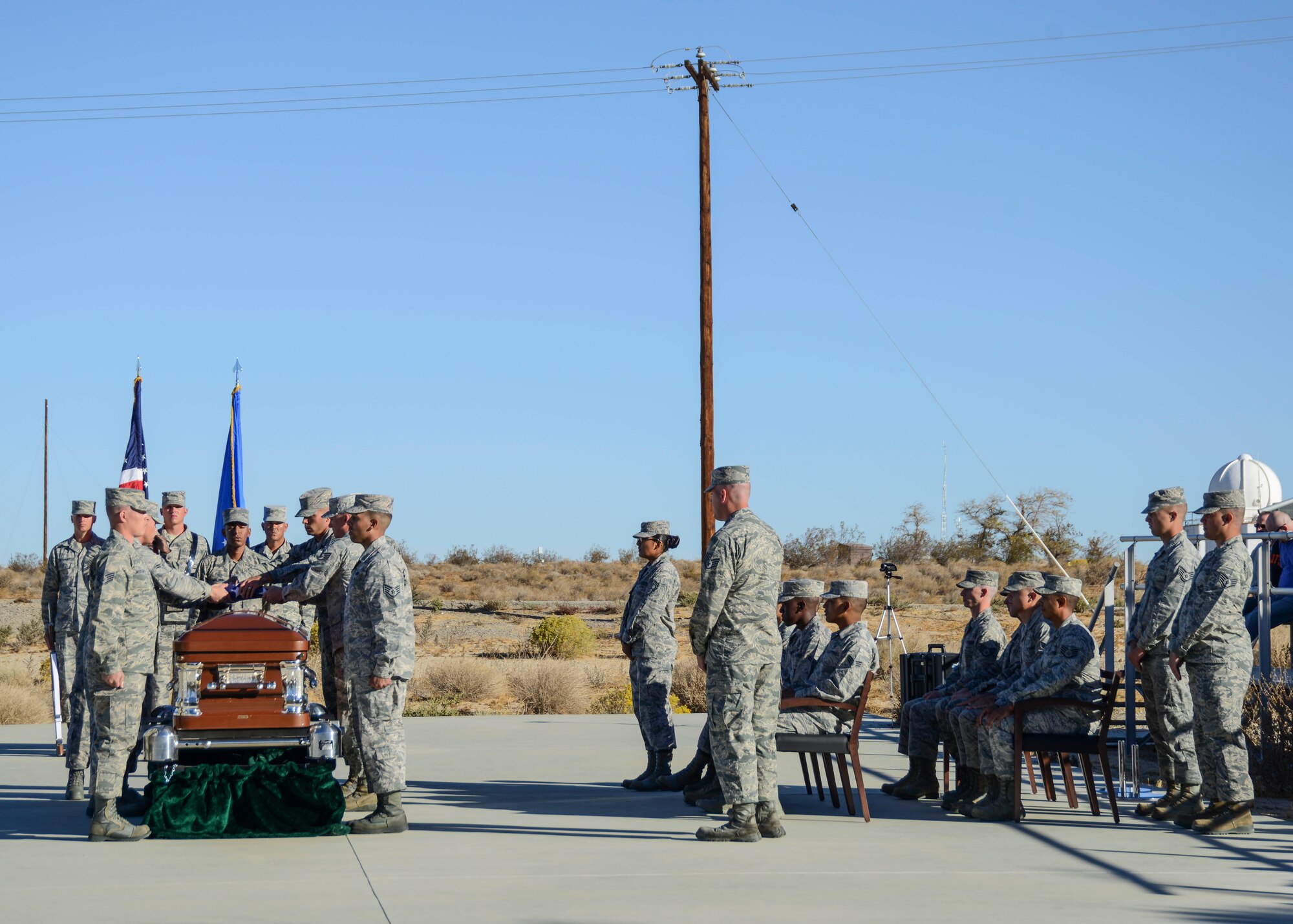 The Blue Eagles Honor Guard graduates perform an active duty mock funeral with a full military honors sequence in front of base leadership and family members Oct. 29, on the Airmen Leadership School Drill Pad. The graduation was the final culmination of a week-long course where instructors from the U.S. Air Force Honor Guard visited the High Desert to train Edwards Airmen.The base honor guard's primary mission is to provide military funeral honors for active duty, retiree and veteran members who served honorably in the United States Air Force and Army Air Corps. The secondary mission of the base honor guard is performing military change of commands, retirements, retreats and other special functions. (U.S. Air Force photo by Rebecca Amber)

