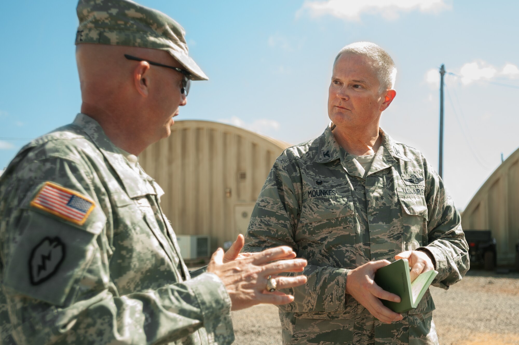 U.S. Army Brig. Gen. Frank W. Tate (left), deputy commanding general of sustainment for Operation United Assistance, speaks with U.S. Air Force Col. David Mounkes, commander of Joint Task Force-Port Opening Senegal, about JTF-PO operations at Léopold Sédar Senghor International Airport in Dakar, Senegal, Oct. 31, 2014. The JTF-PO, staffed by more than 70 members of the Kentucky Air National Guard’s 123rd Contingency Response Group, is funneling humanitarian supplies and military support into West Africa as part of the U.S. Agency for International Development-led, whole-of-government effort to contain the Ebola virus outbreak. (U.S. Air National Guard photo by Maj. Dale Greer)