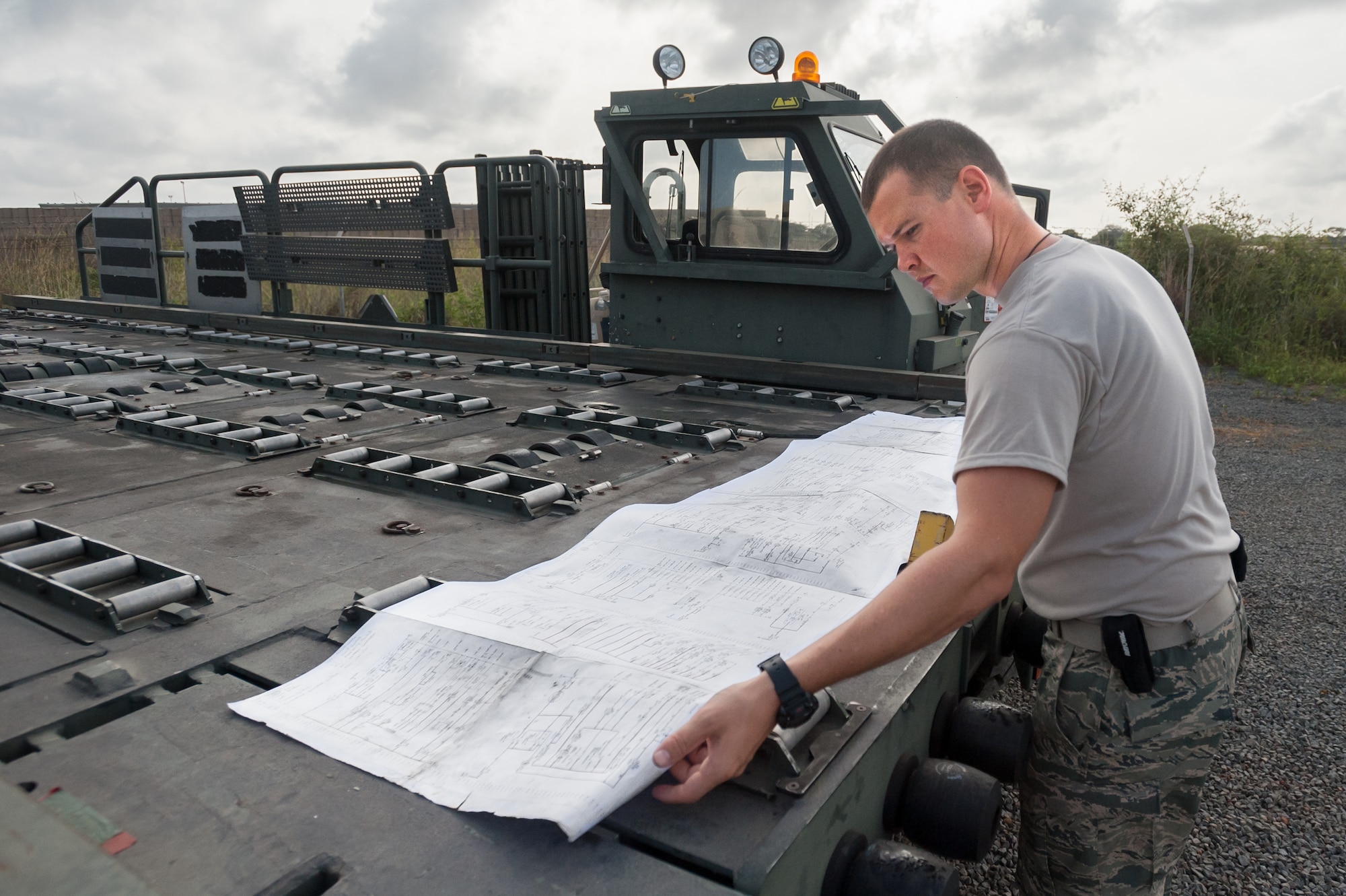 U.S. Air Force Staff Sgt. Joshua Orme, a special vehicle mechanic for the Kentucky Air National Guard’s 123rd Contingency Response Group, reads the electrical schematics for a 25,000-pound Halvorsen Loader while performing maintenance on the cargo-handling vehicle outside the Joint Operations Center at Léopold Sédar Senghor International Airport in Dakar, Senegal, Oct. 27, 2014. More than 70 Kentucky Air Guardsmen are operating an Aerial Port of Debarkation in Senegal to funnel humanitarian supplies and military support into West Africa as part of Operation United Assistance, the U.S. Agency for International Development-led, whole-of-government effort to contain the Ebola virus outbreak. (U.S. Air National Guard photo by Maj. Dale Greer)