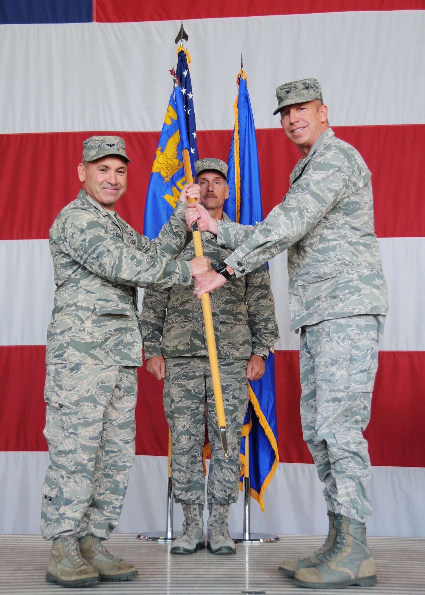 Col. Kurt Gallegos, 944th Fighter Wing commander, hands the 944th Mission Support Group guidon to Col. Paul Theisen, 944th Mission Support Group commander, November 2 during a change of command ceremony at Luke Air Force Base, Ariz. (U.S. Air Force photo taken by Staff Sgt. Joshua Nason)
