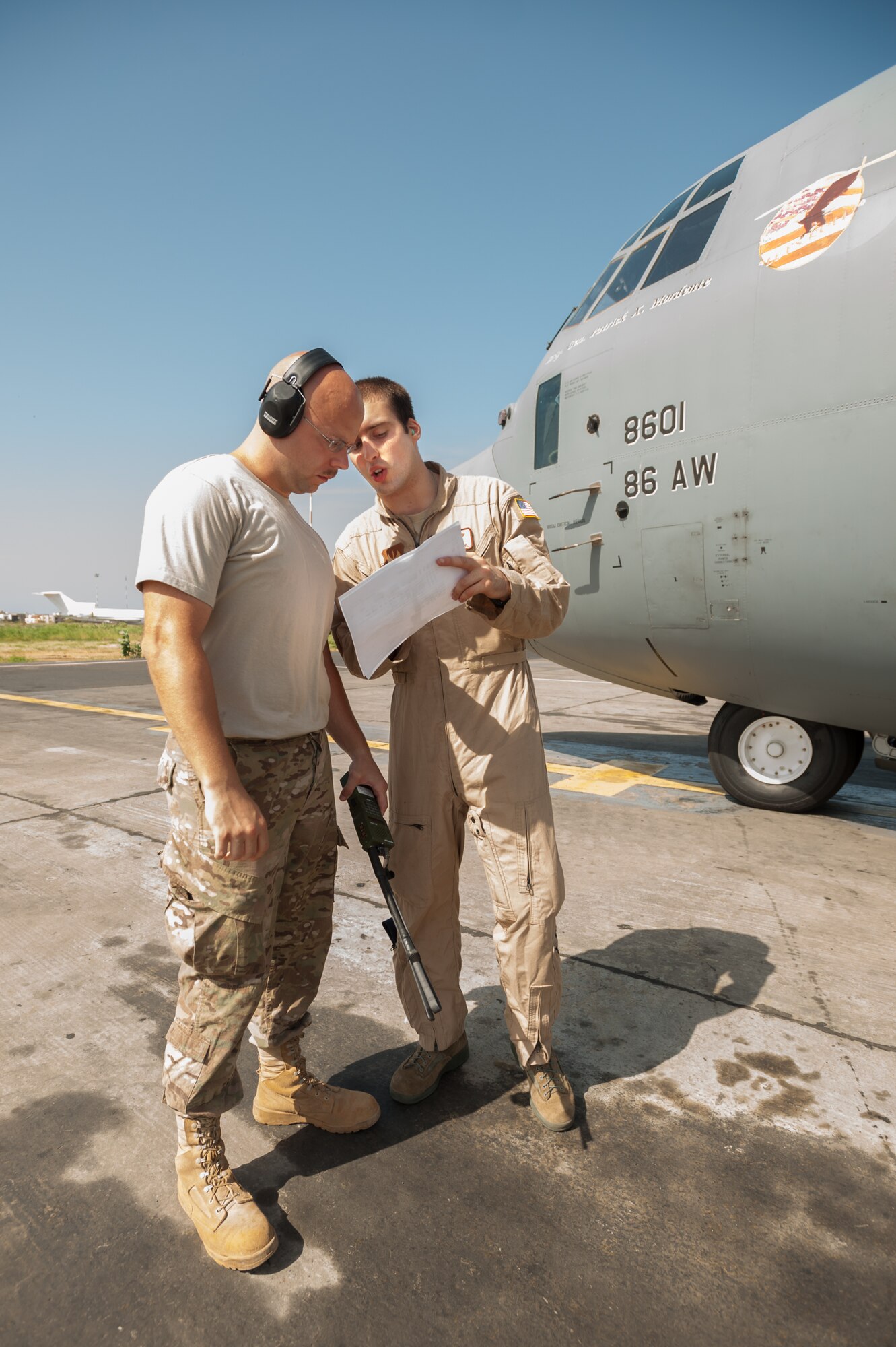 U.S. Air Force Tech. Sgt. Jarrod Blanford, an aerial porter from the Kentucky Air National Guard’s 123rd Contingency Response Group (left), reviews a cargo manifest with U.S. Air Force Airman 1st Class Evan Kuehl, a loadmaster from the 86th Airlift Wing, prior to the departure of a C-130 Hercules from Léopold Sédar Senghor International Airport in Dakar, Senegal, Oct. 22, 2014. The flight is bound for Liberia, carrying whole blood and U.S. Army Soldiers supporting Operation United Assistance, the U.S. Agency for International Development-led, whole-of-government effort to respond to the Ebola outbreak in West Africa. (U.S. Air National Guard photo by Maj. Dale Greer)