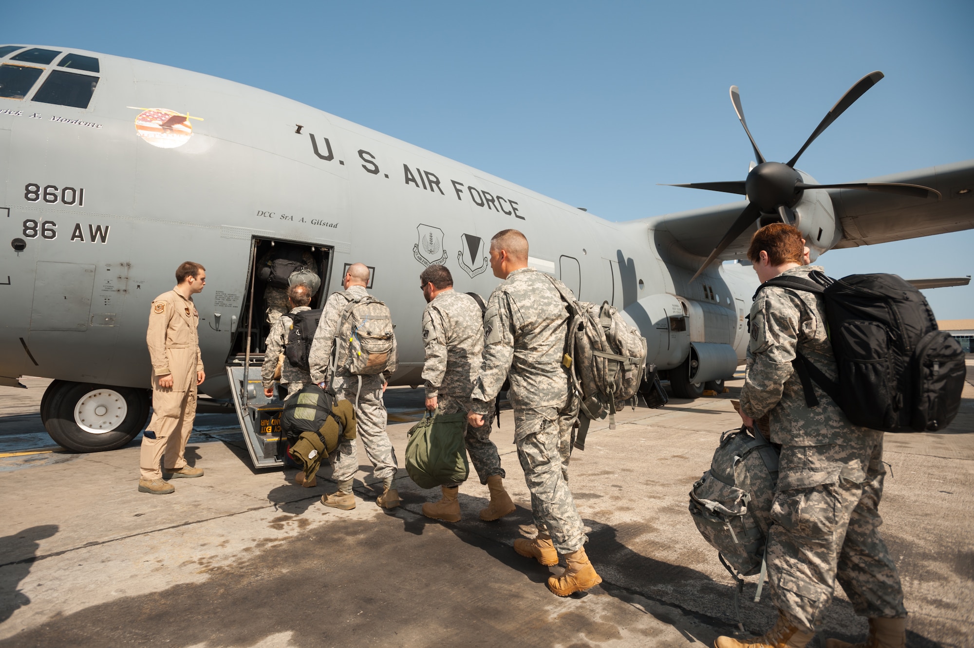 A group of service members, including Soldiers from the U.S. Army Corps of Engineers’ Forward Engineering Support Team based in Wiesbaden, Germany, boards a U.S. Air Force C-130 Hercules at Léopold Sédar Senghor International Airport in Dakar, Senegal, Oct. 22, 2014. The engineers are bound for Liberia, where they will build medical treatment units as part of Operation United Assistance, the U.S. Agency for International Development-led, whole-of-government effort to respond to the Ebola outbreak in West Africa. The Soldiers’ departure was coordinated by Airmen from the Kentucky Air National Guard’s 123rd Contingency Response Group, which operates an Intermediate Staging Base at the Dakar airport. (U.S. Air National Guard photo by Maj. Dale Greer)