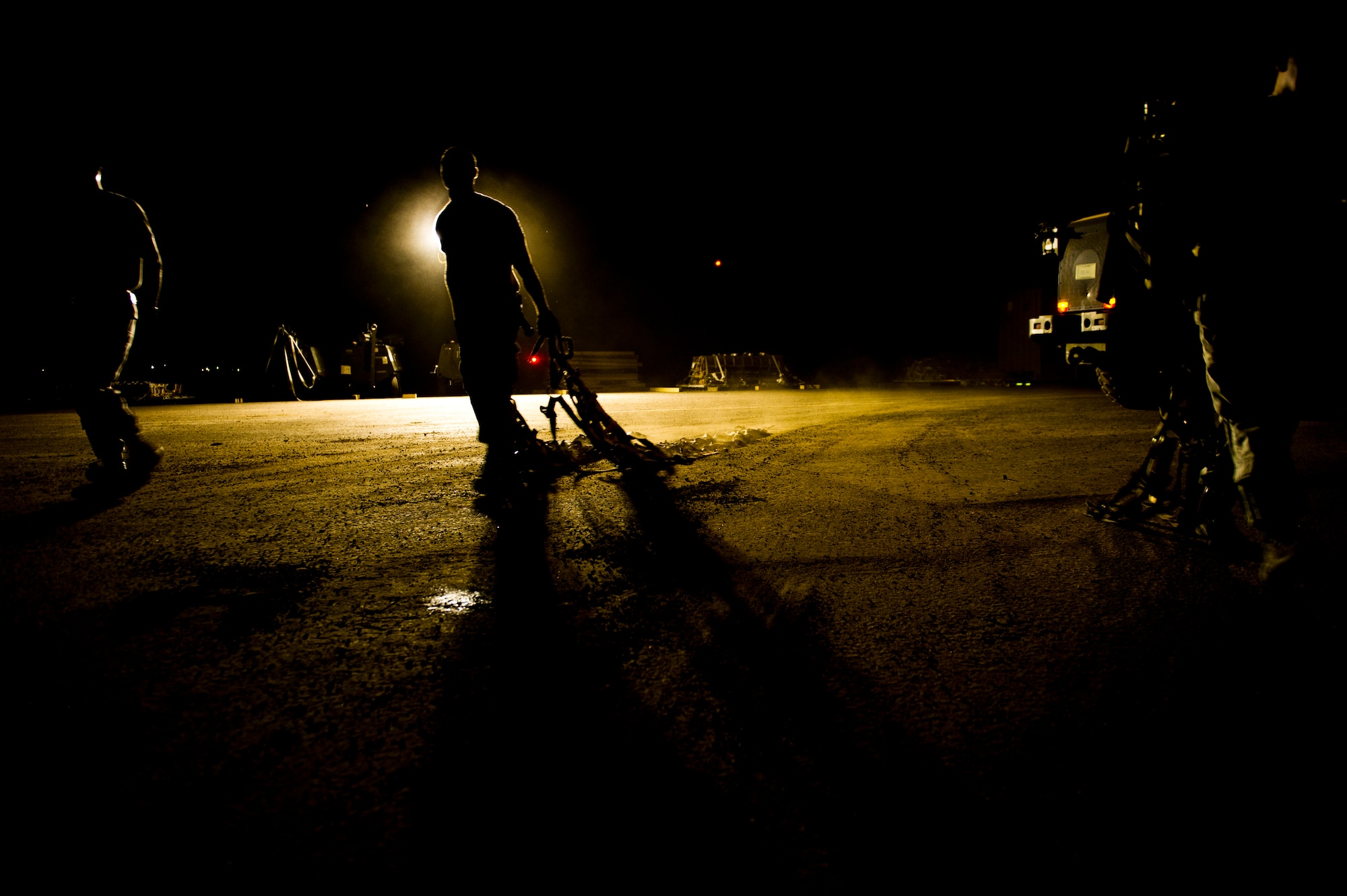 U.S. Air Force Airmen of the Joint Task Force-Port Opening of the 621st Contingency Response Wing stationed at Joint Base McGuire-Dix-Lakehurst, N.J., drags cargo nets out of the cargo yard here, during Operation United Assistance, Nov. 2, 2014. OUA is a Joint Forces Command-led operation to provide command and control, logistics, training and engineering support to the U.S. government’s efforts to contain the Ebola virus outbreak in West African nations. (U.S. Air Force photo by Staff Sgt. Gustavo Gonzalez/Released)