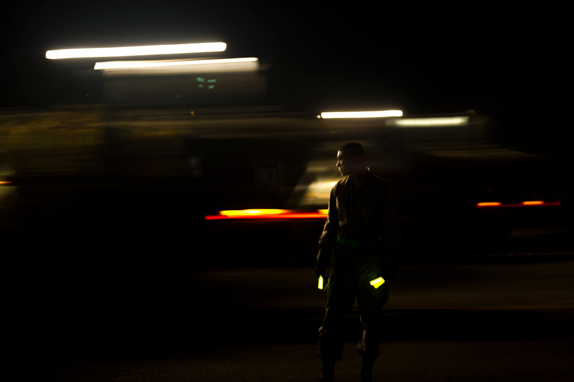 U.S. Air Force Airman 1st Class Cole Wall, an aerial porter of the Joint Task Force-Port Opening of the 621st Contingency Response Wing stationed at Joint Base McGuire-Dix-Lakehurst, N.J., helps direct traffic in a cargo yard here, during Operation United Assistance, Nov. 2, 2014. OUA is a Joint Forces Command-led operation to provide command and control, logistics, training and engineering support to the U.S. government’s efforts to contain the Ebola virus outbreak in West African nations. (U.S. Air Force photo by Staff Sgt. Gustavo Gonzalez/Released)